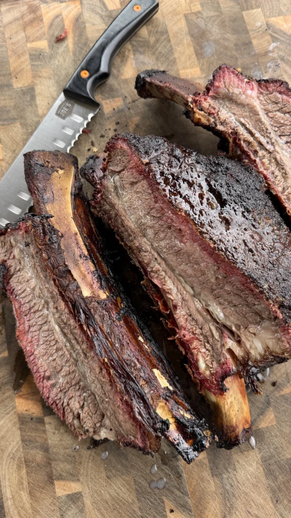 smoked beef ribs on a cutting board
