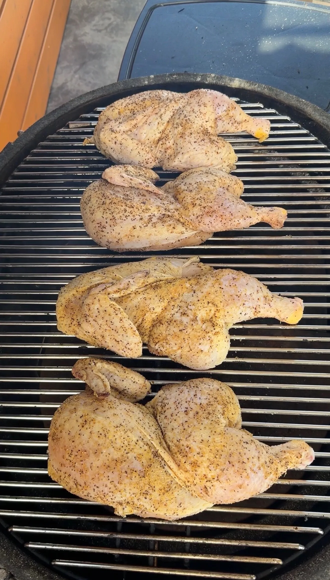 Applewood smoked half chickens on grill grates