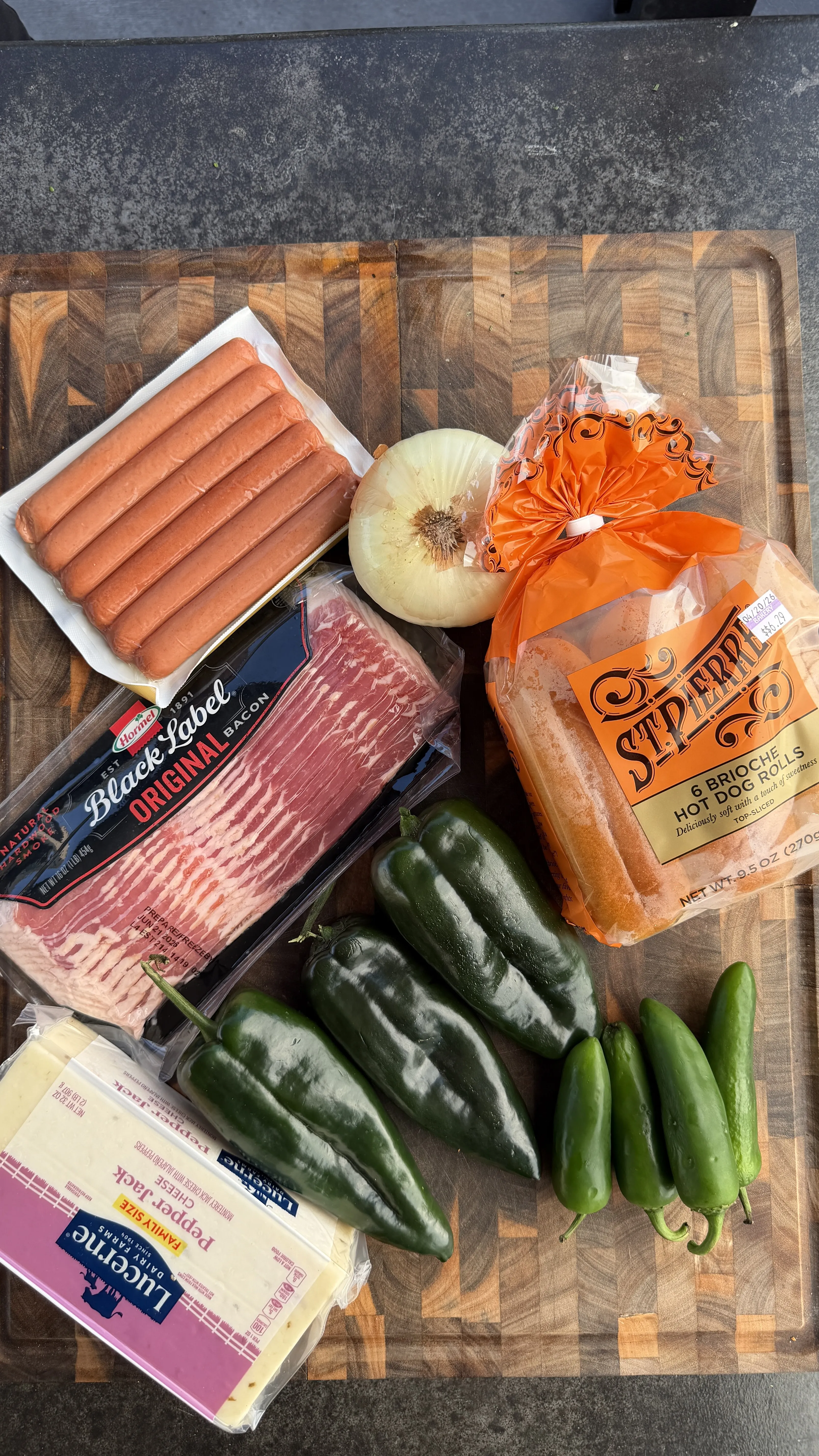 Bacon-wrapped chile relleno hot dog ingredients on cutting board