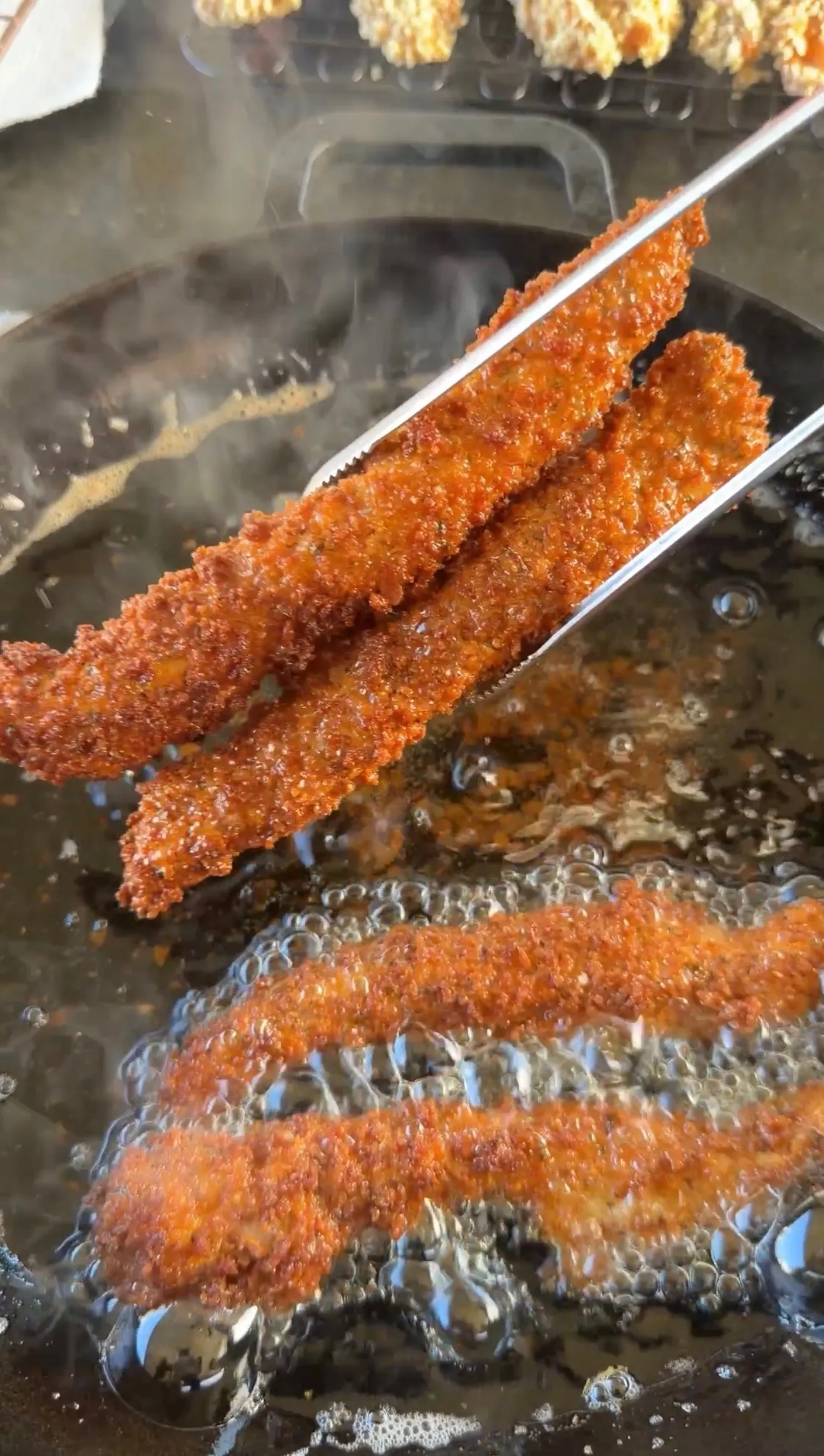Crispy chicken fries frying in oil