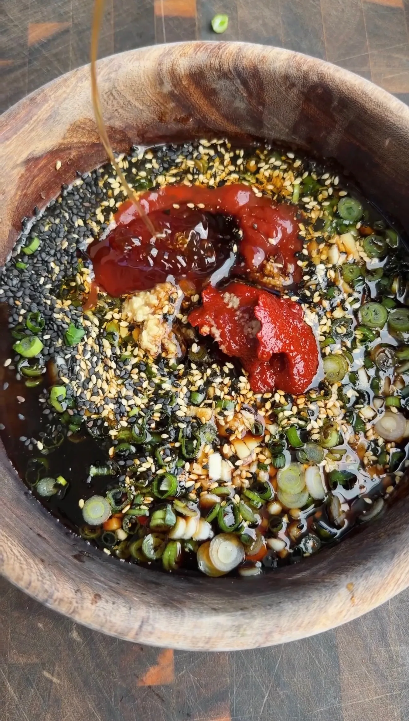 Garlic chili sesame marinade sauce in wooden bowl