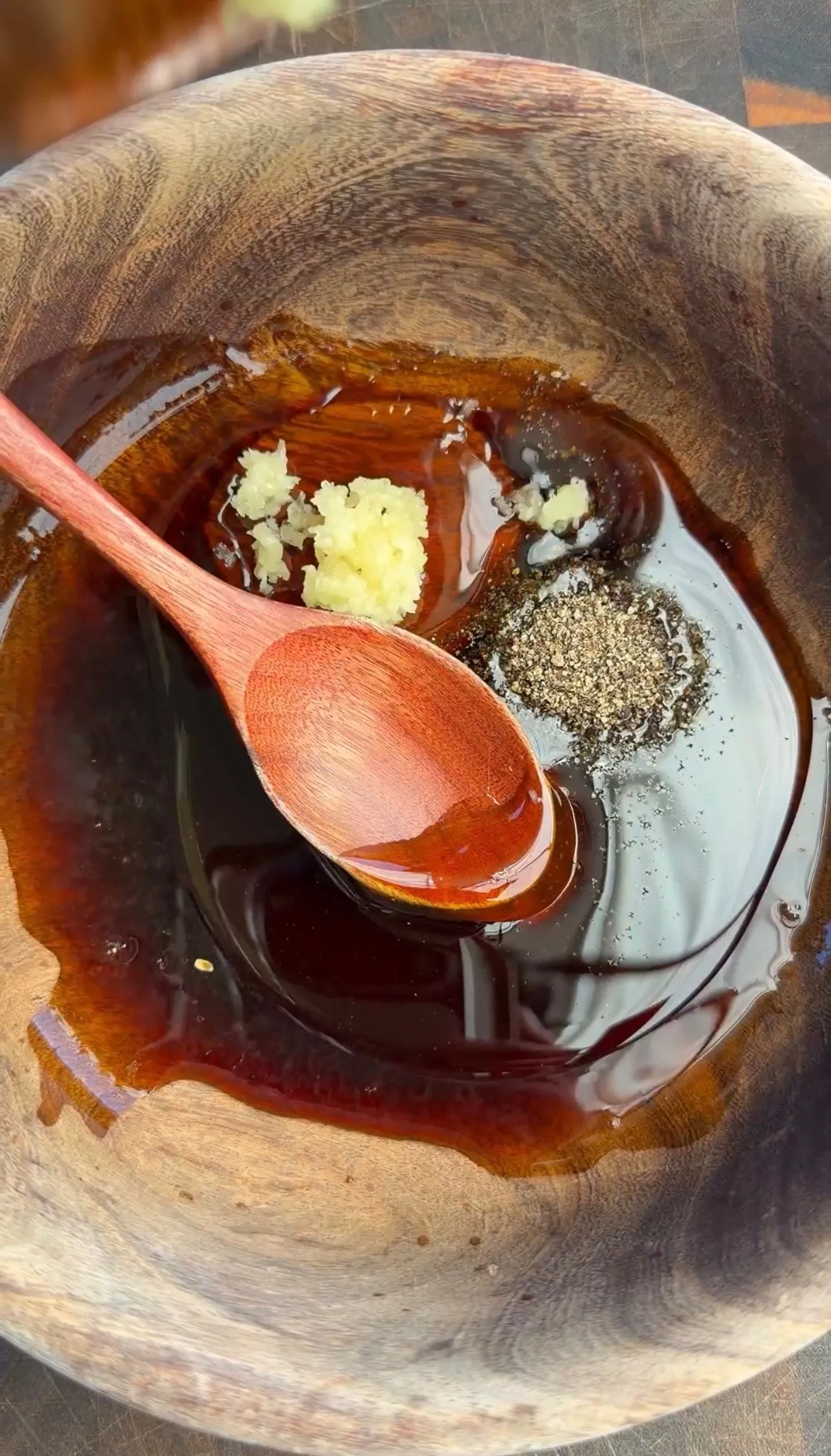 Garlic soy honey marinade in wooden bowl