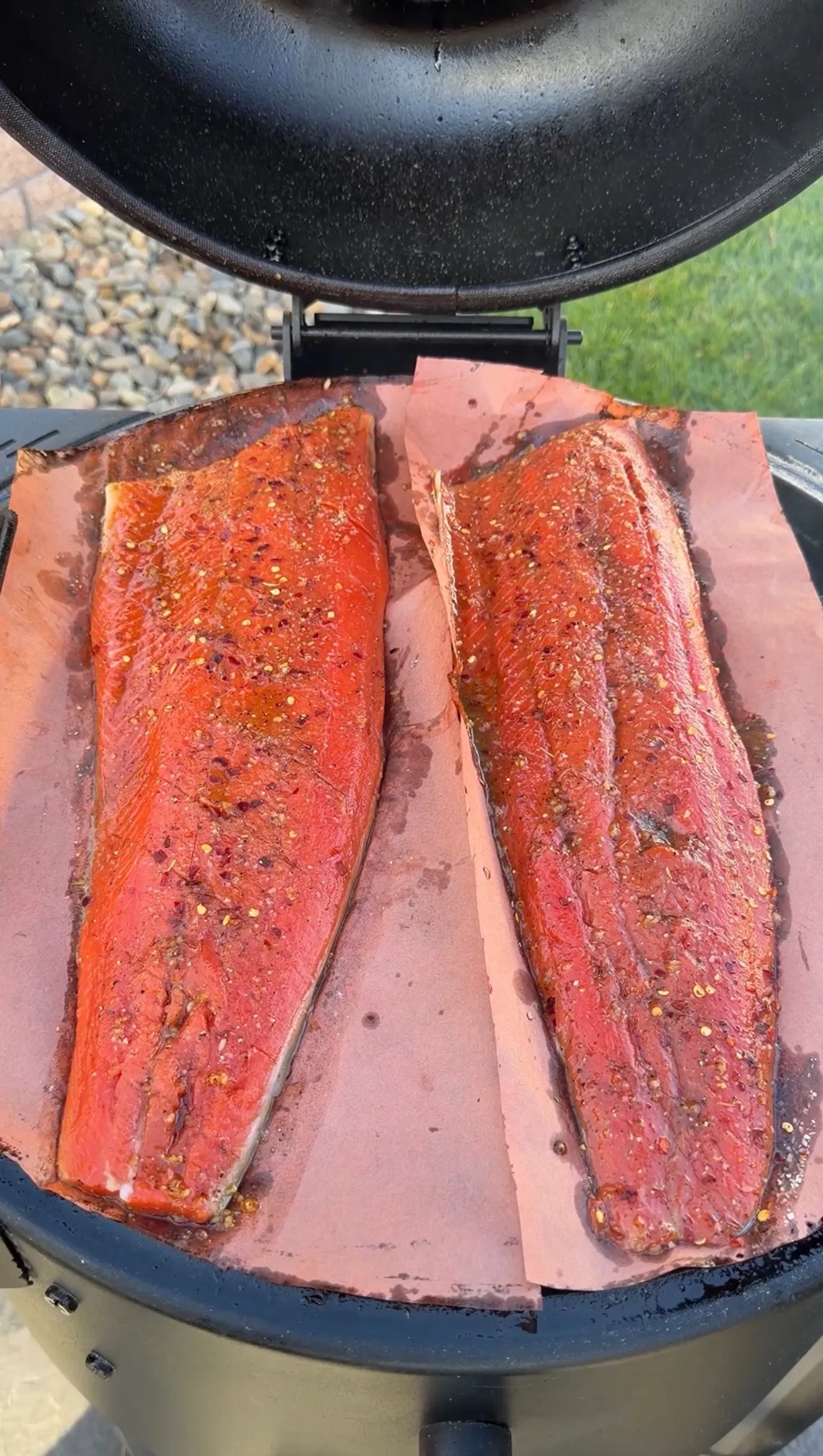 Garlic soy honey salmon fillets smoking on grill