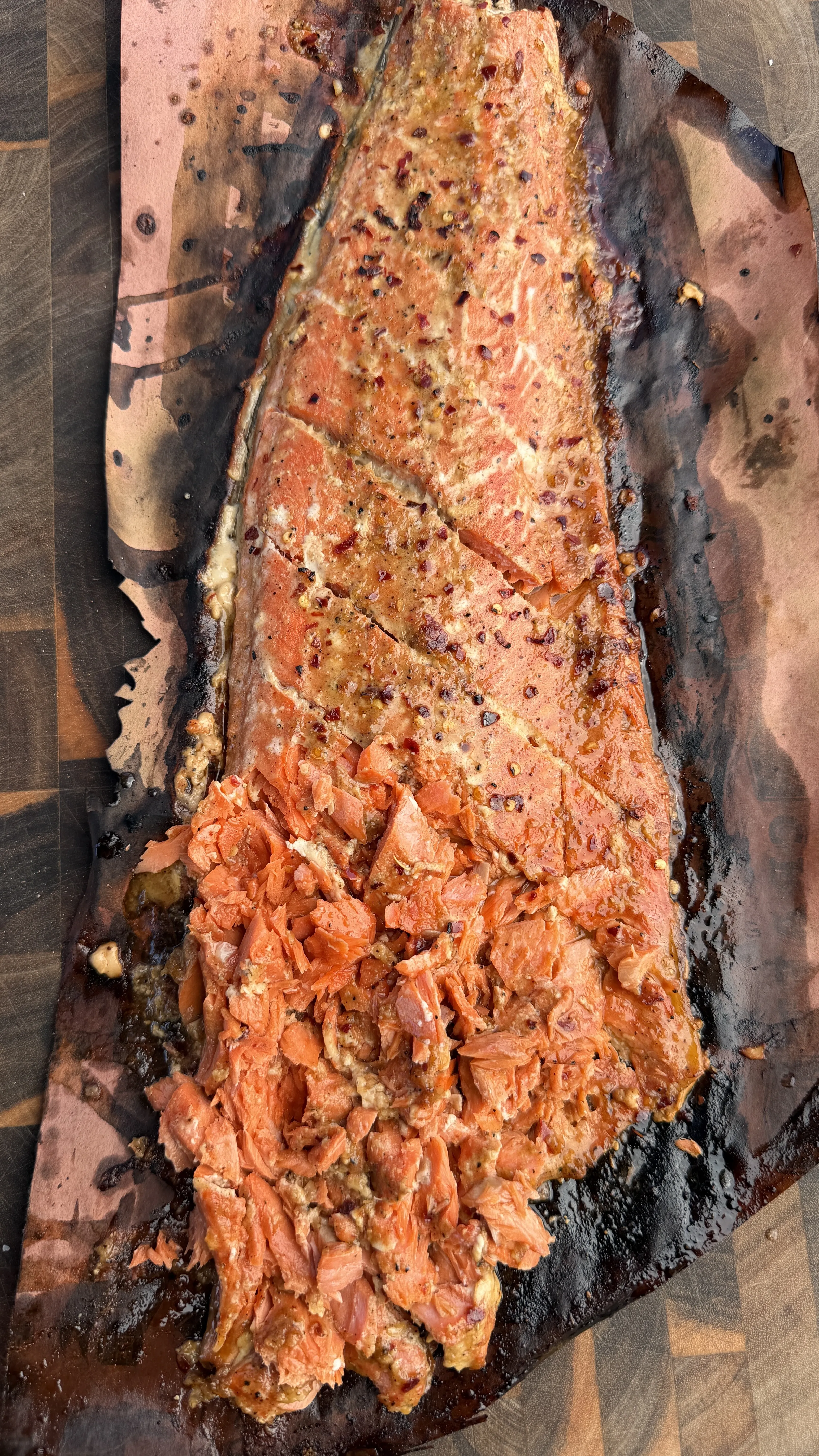 Garlic soy honey smoked salmon flaked on parchment