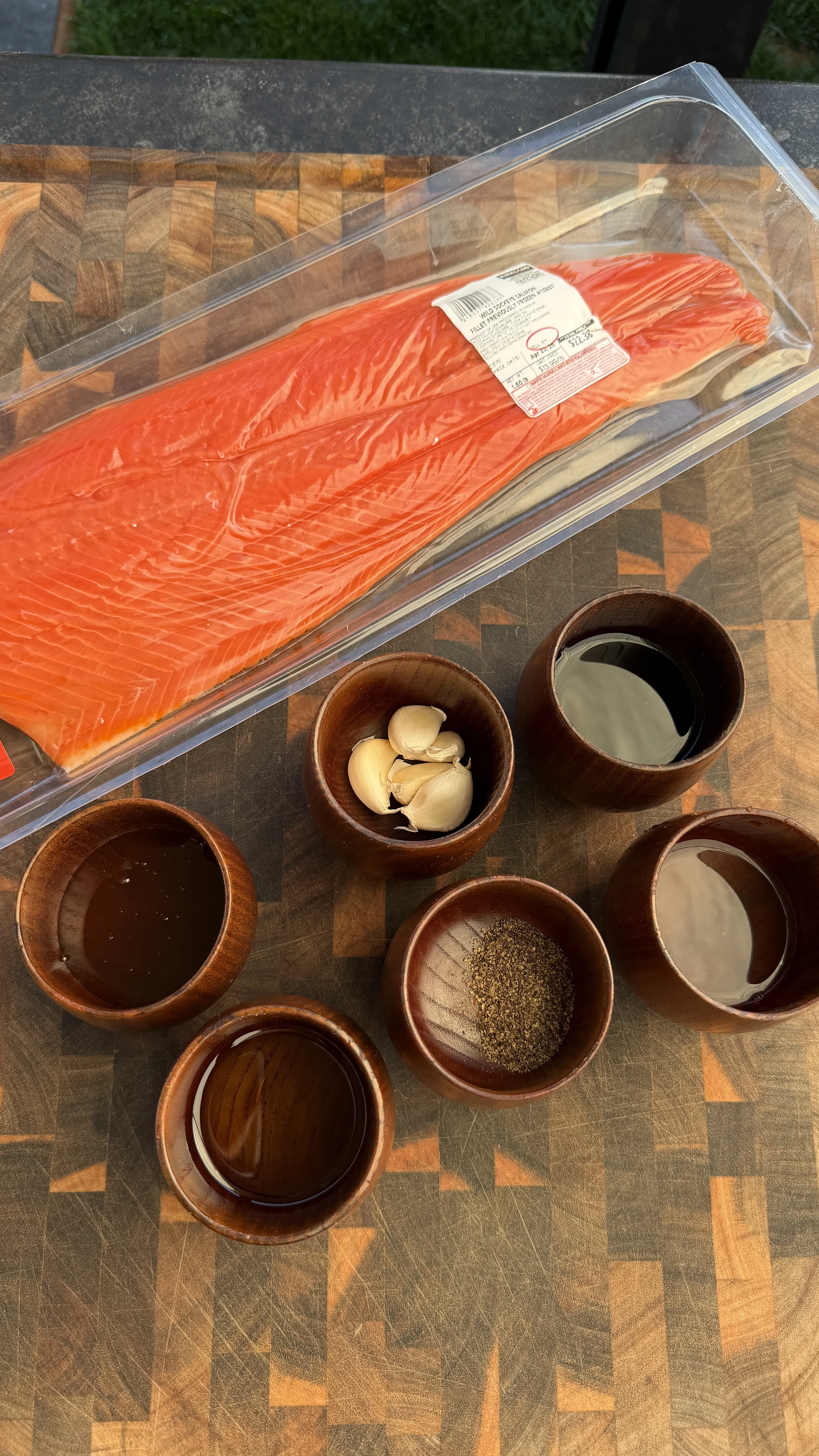 Raw salmon fillet with marinade ingredients during prep