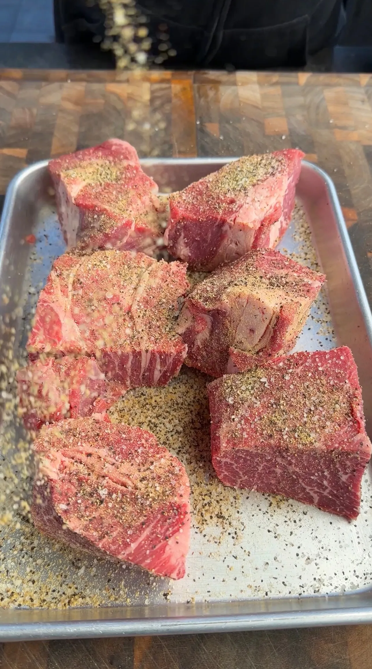 Seasoned beef on tray for birria prep