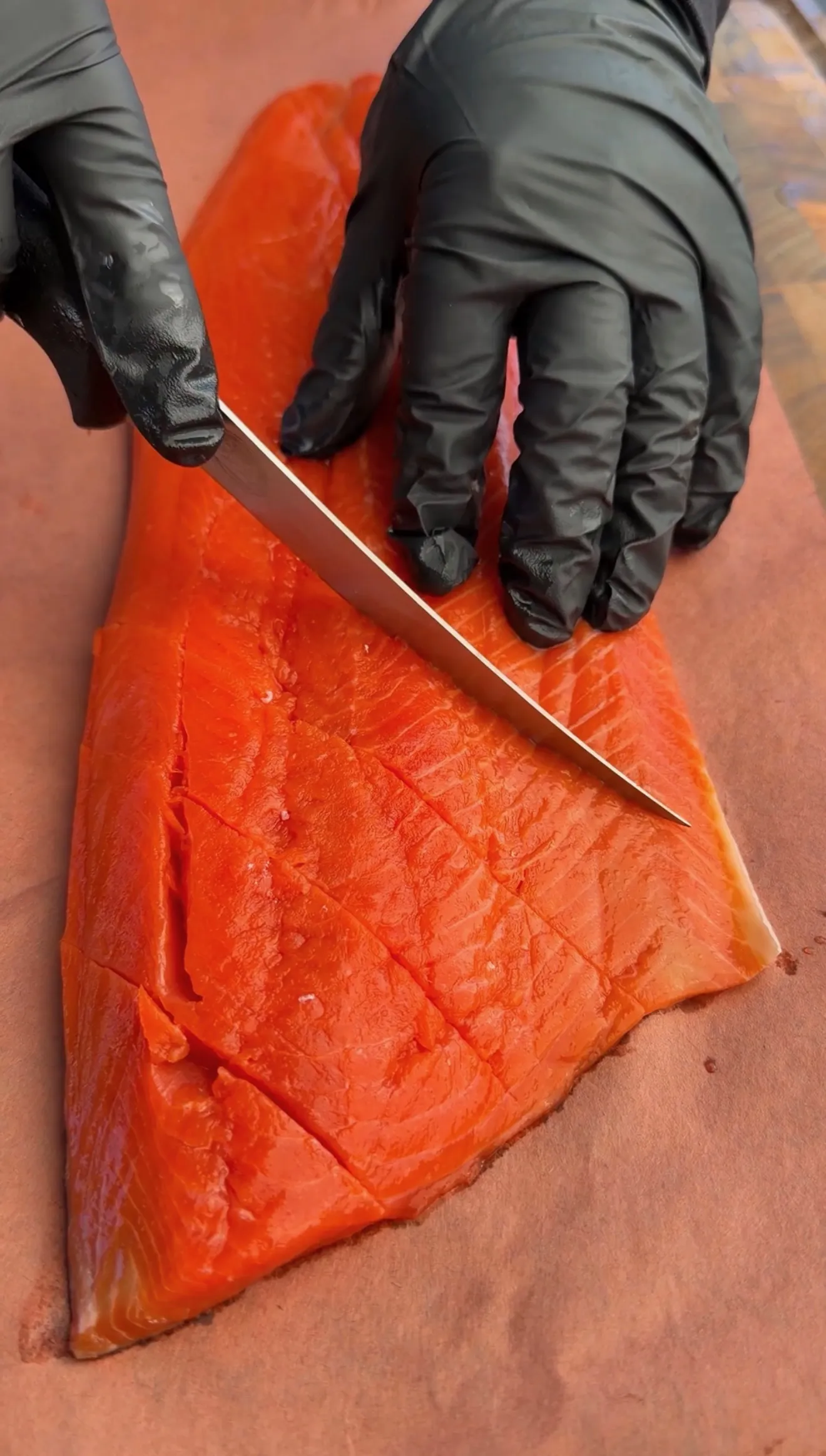 Slicing crosshatch pattern into salmon fillet