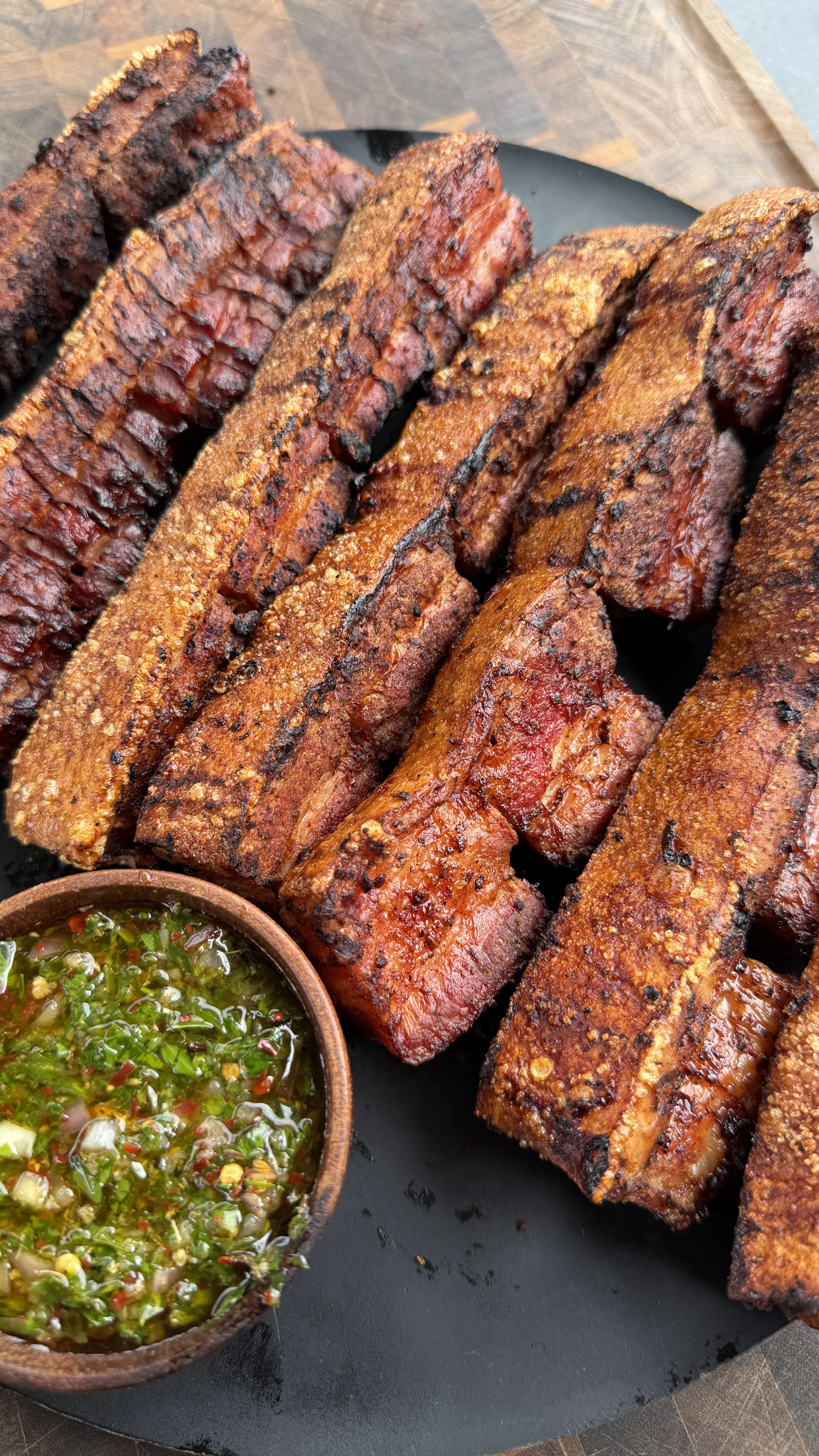 Smoked and fried pork belly slices with chimichurri