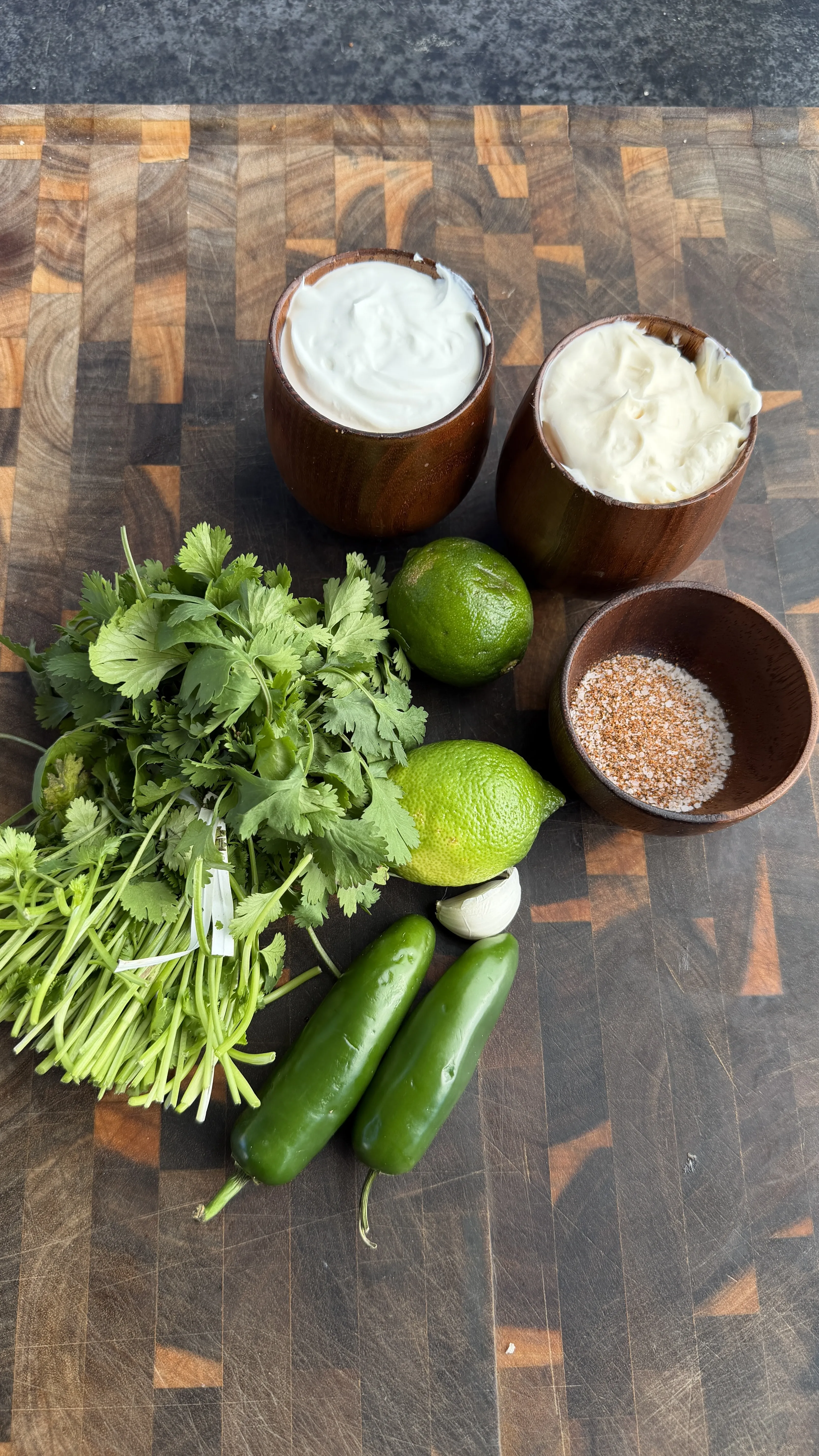 Taquito ingredients with fresh cilantro and lime in coconut bowls