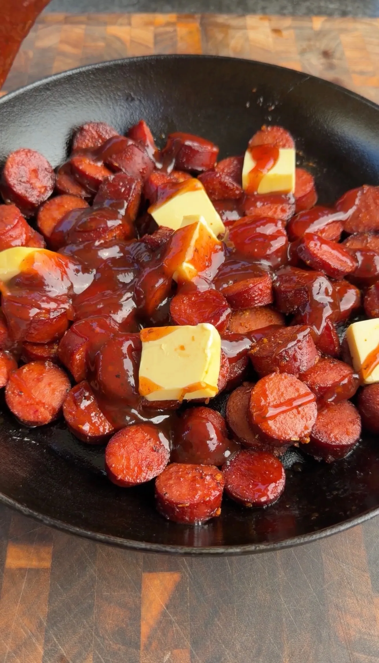 BBQ smoked sausage burnt ends with butter in skillet