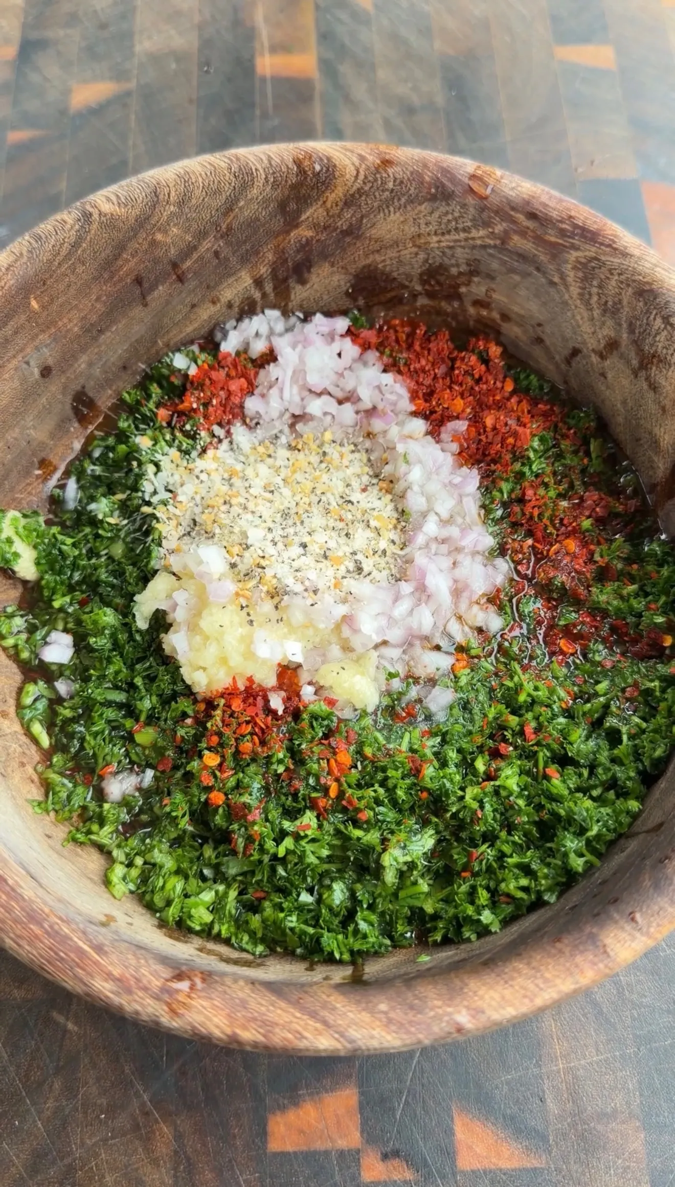 Board sauce ingredients in wooden bowl during prep