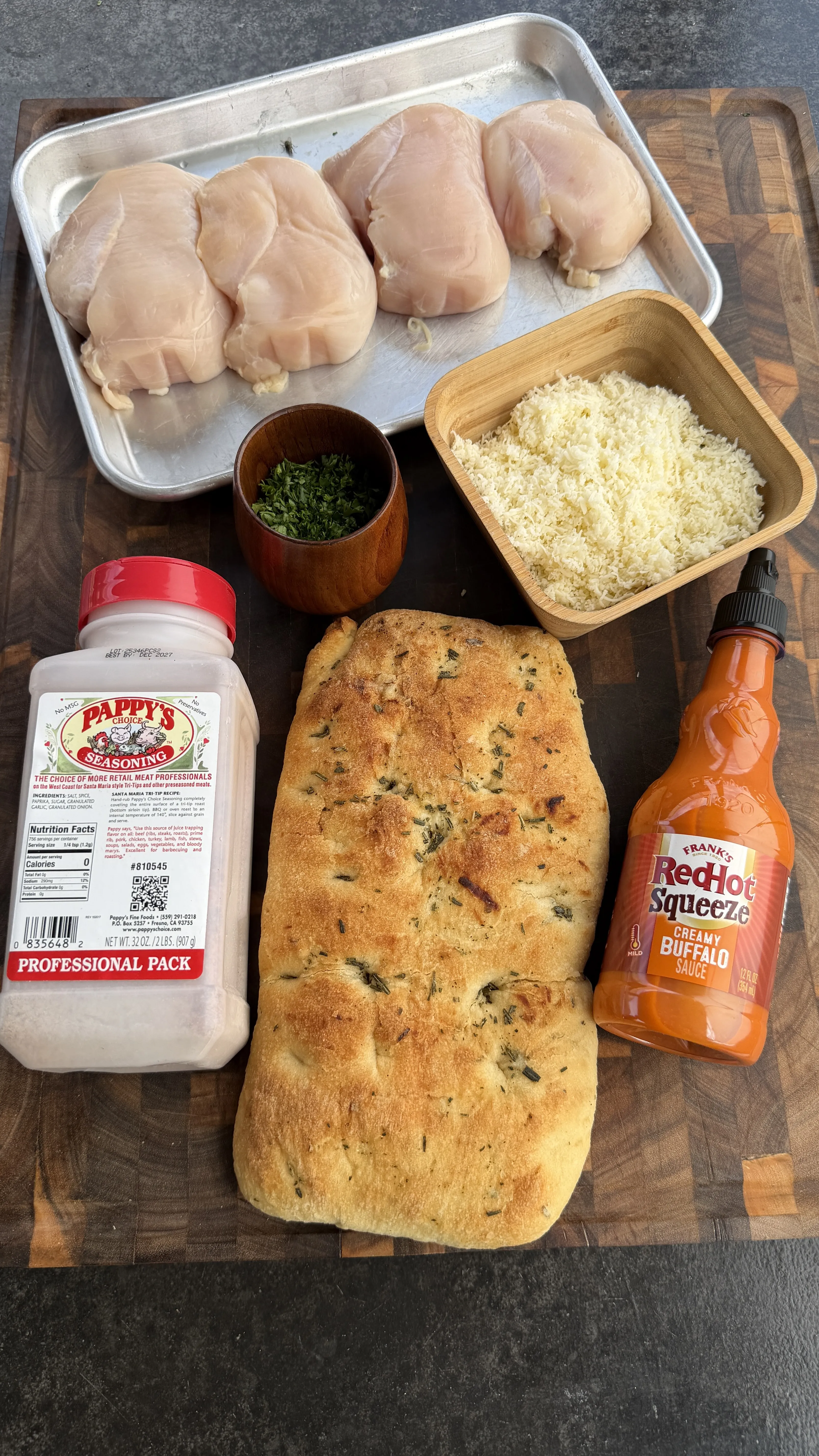 Buffalo chicken flatbread ingredients on prep board