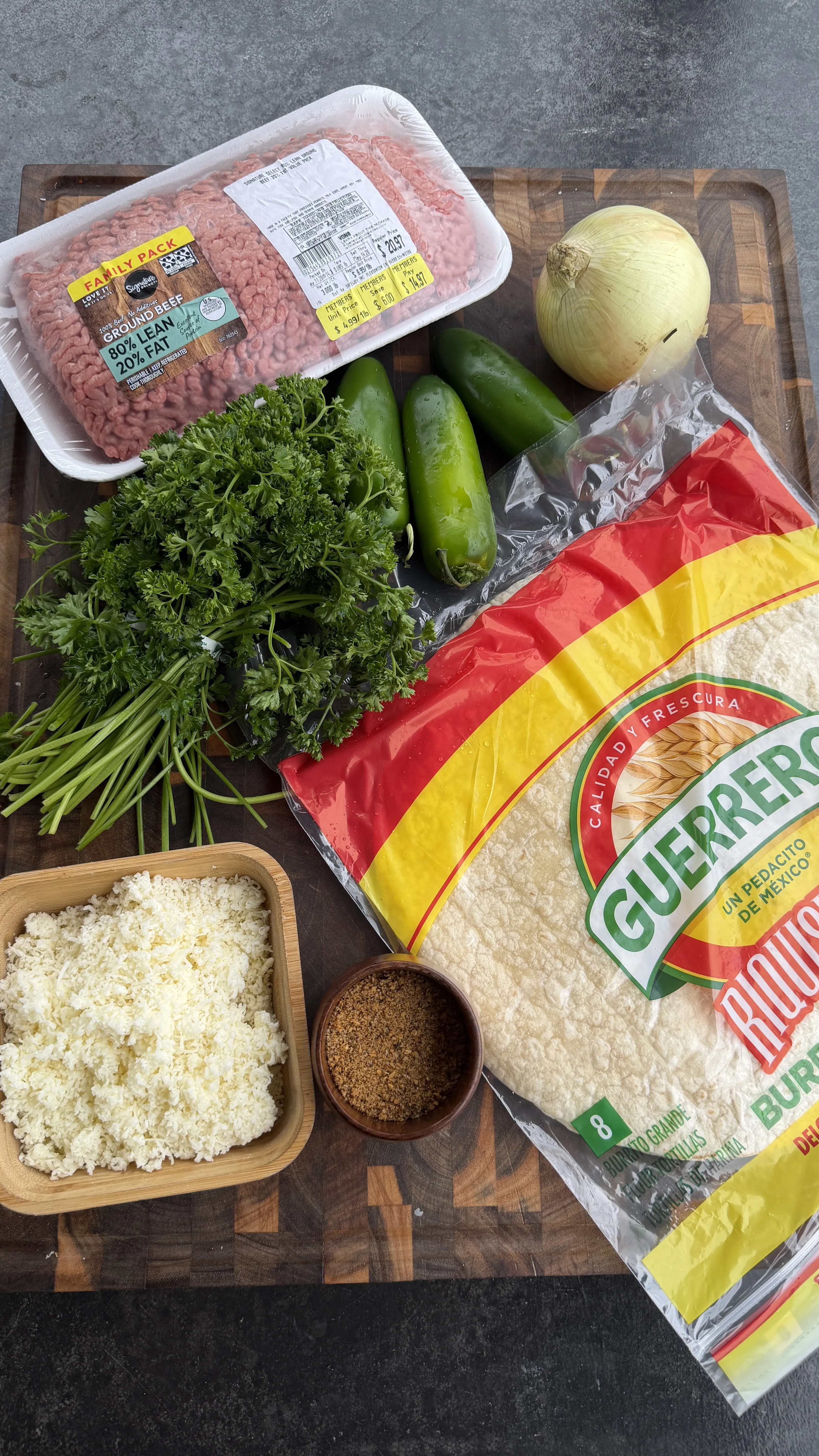 Ingredients for cheesy beef tortilla pinwheels including ground beef, tortillas, cheese, jalapeños and onion