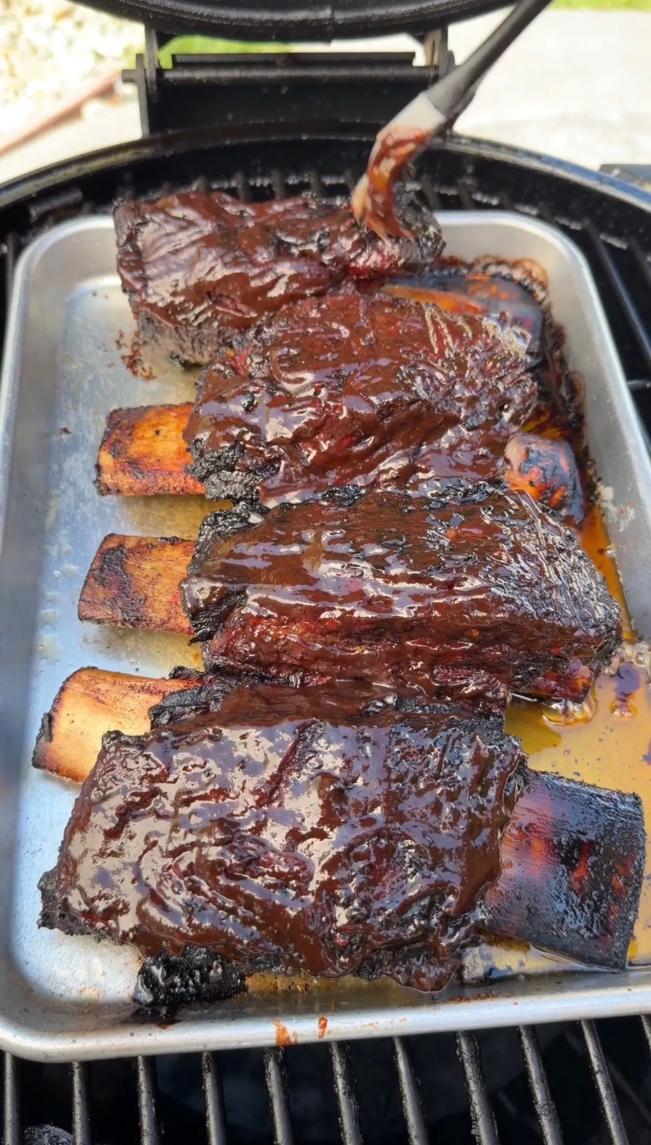 Glazed smoked beef ribs in barbecue pan