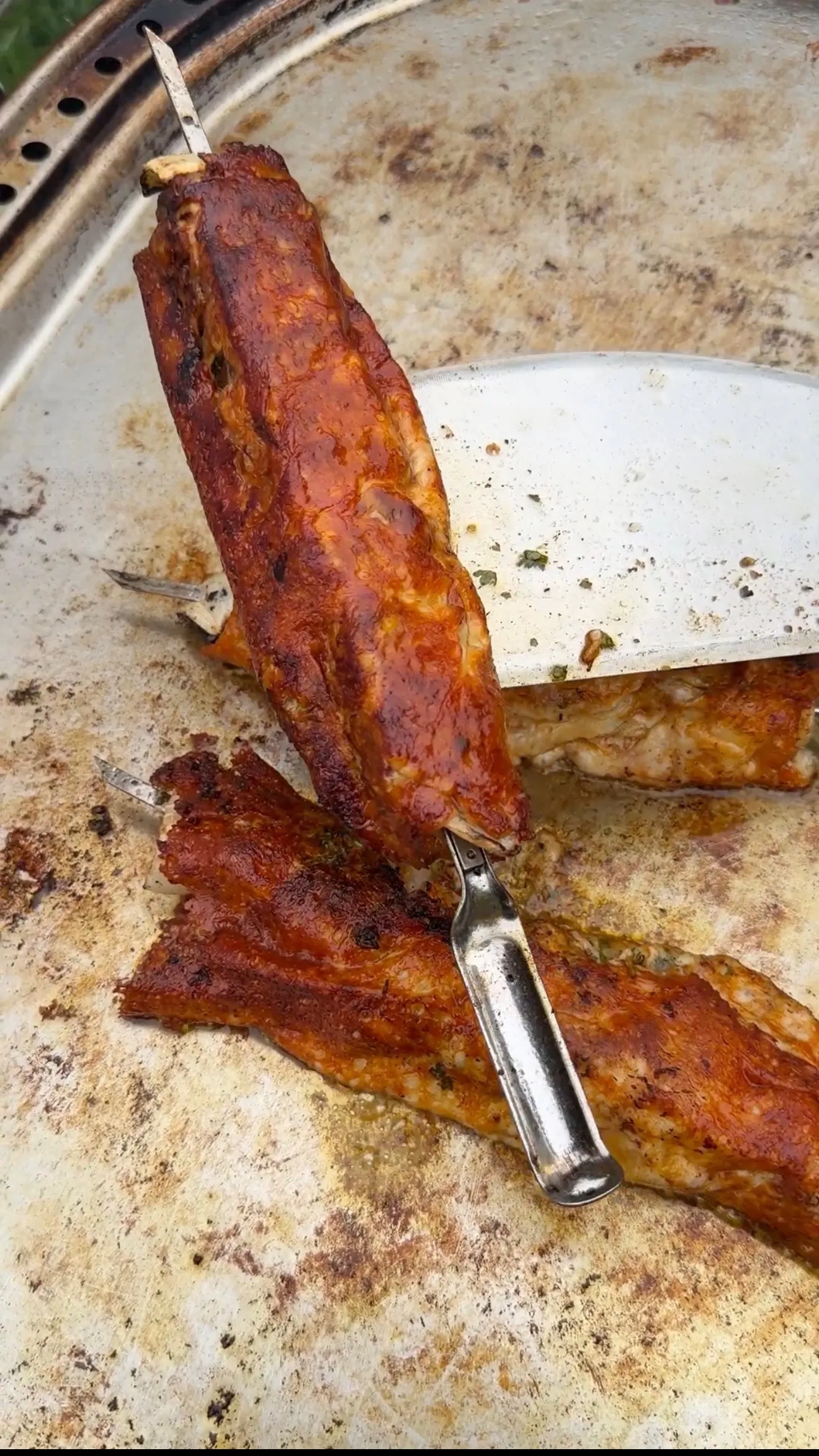 Grilled cheese-crusted chimichurri steak kebabs on metal spatula showing golden-brown crust and char marks