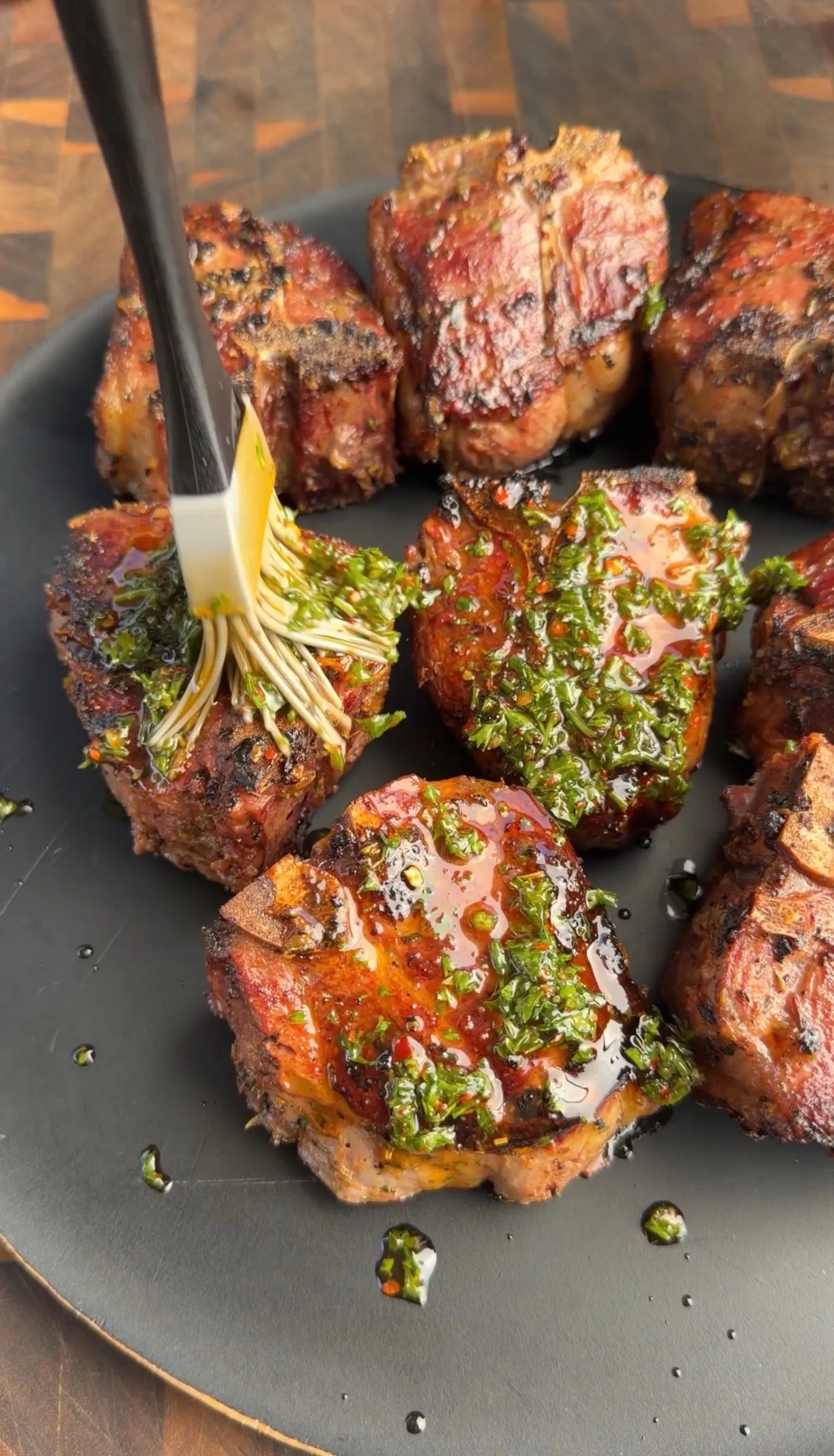 Grilled lamb chops with herb sauce on grill