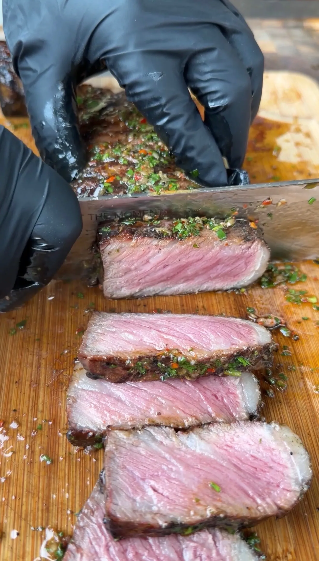 Grilled strip steak sliced with board sauce