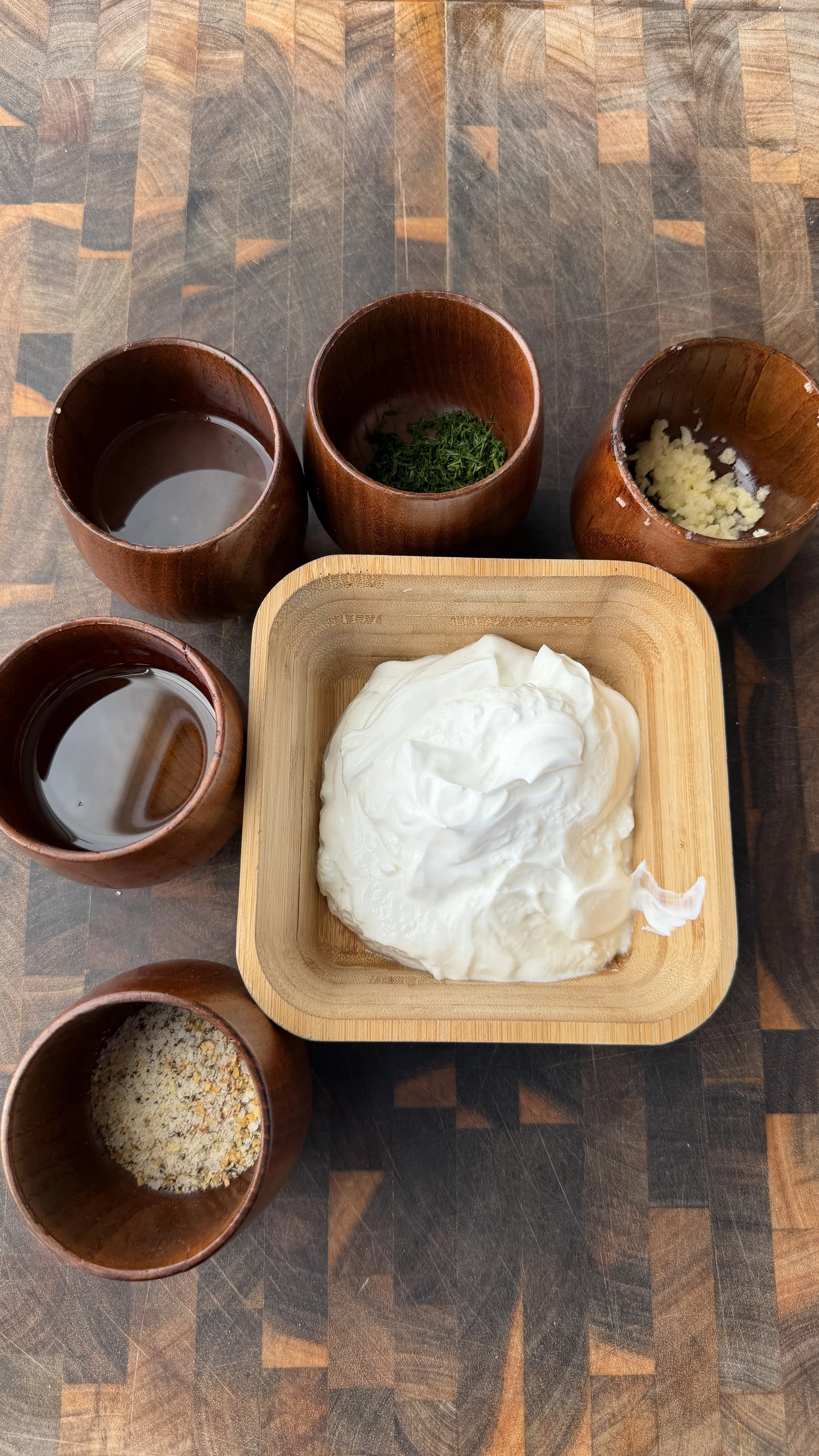 Harissa chicken marinade ingredients in wooden bowls