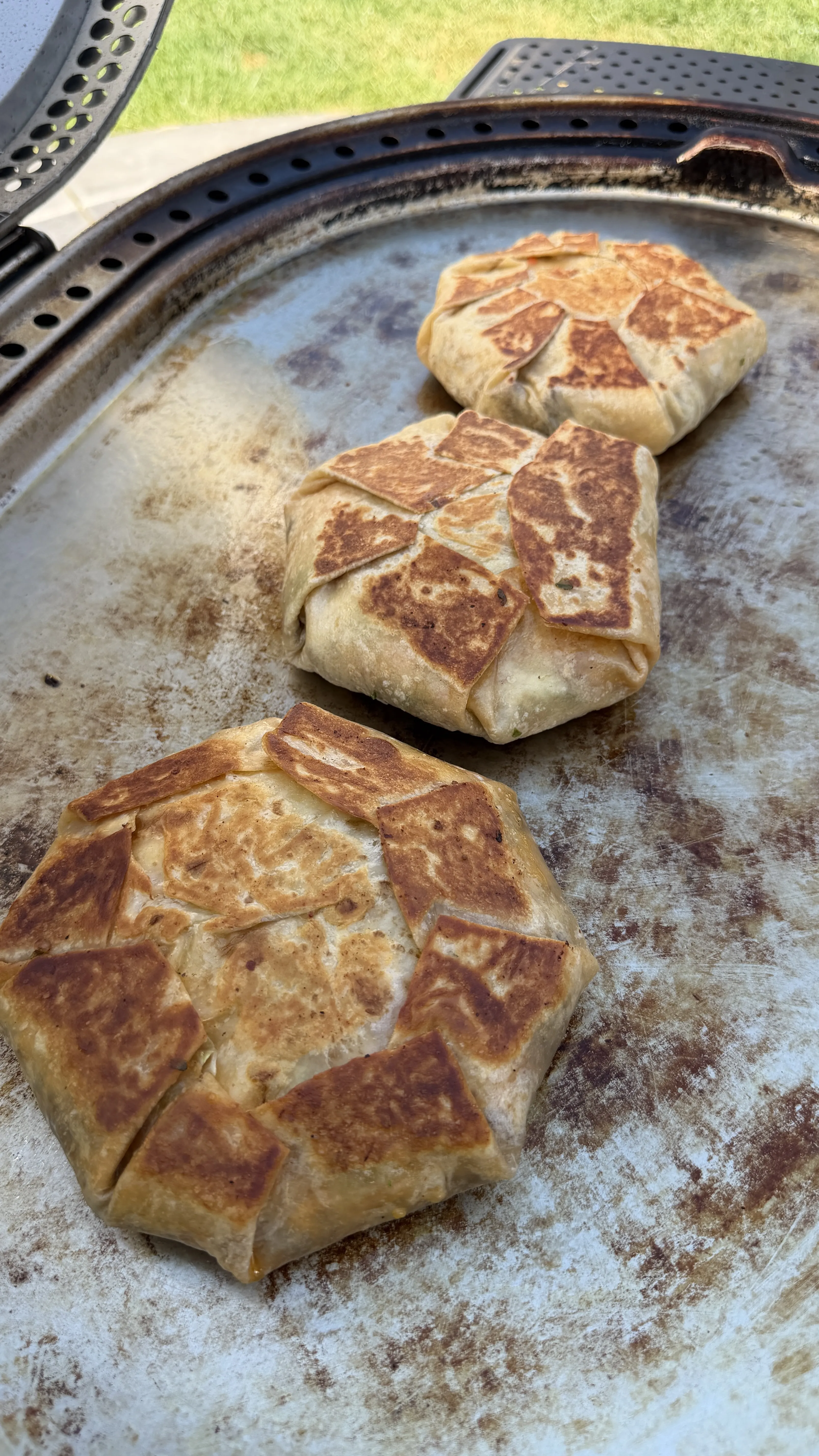 Homemade crunchwrap grilling on outdoor griddle