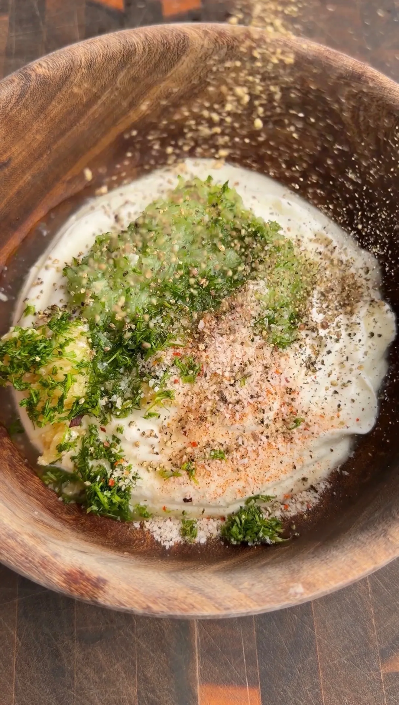 Lamb marinade with herbs and spices in wooden bowl