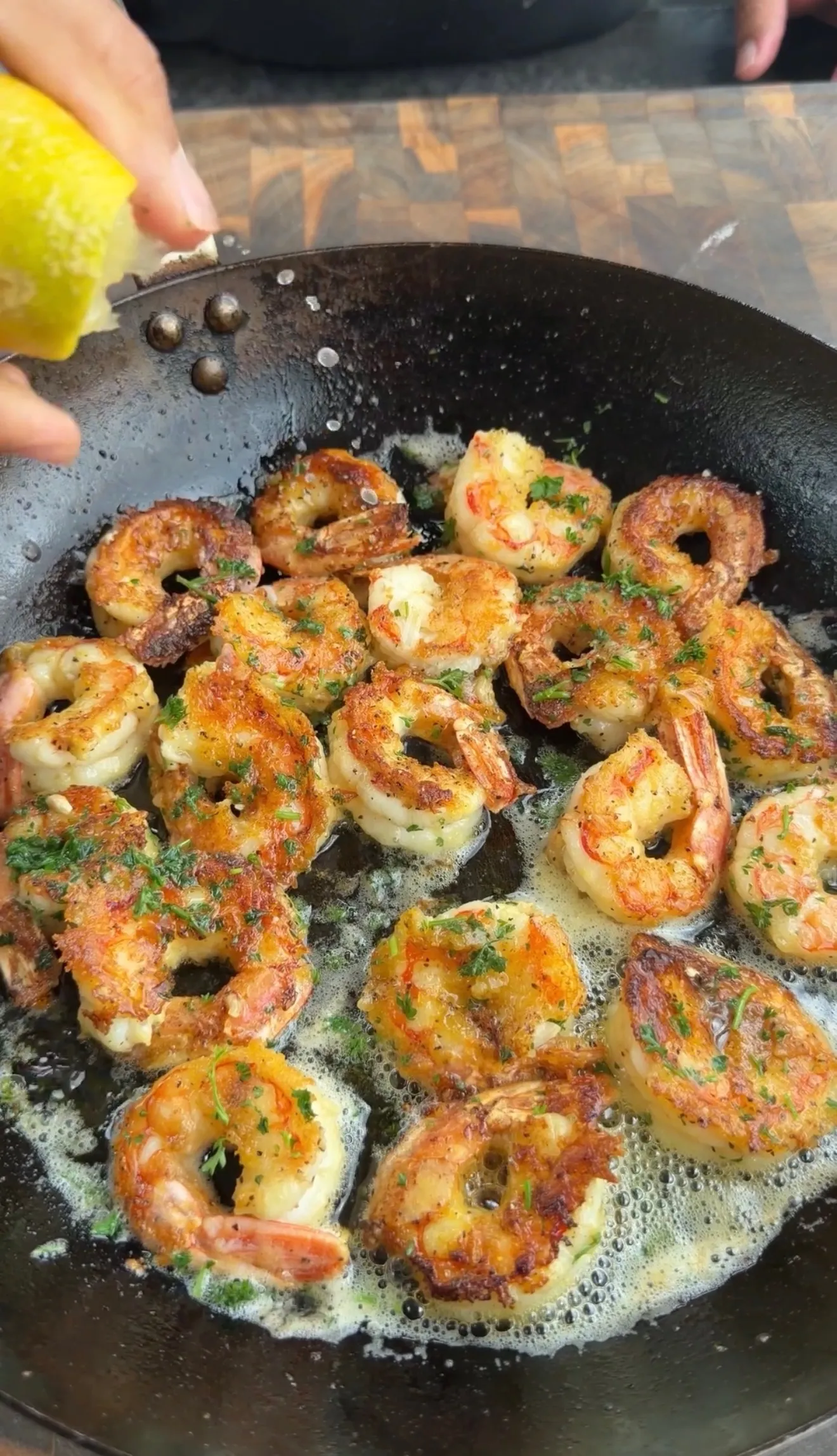 Lemon pepper crispy shrimp sizzling in pan