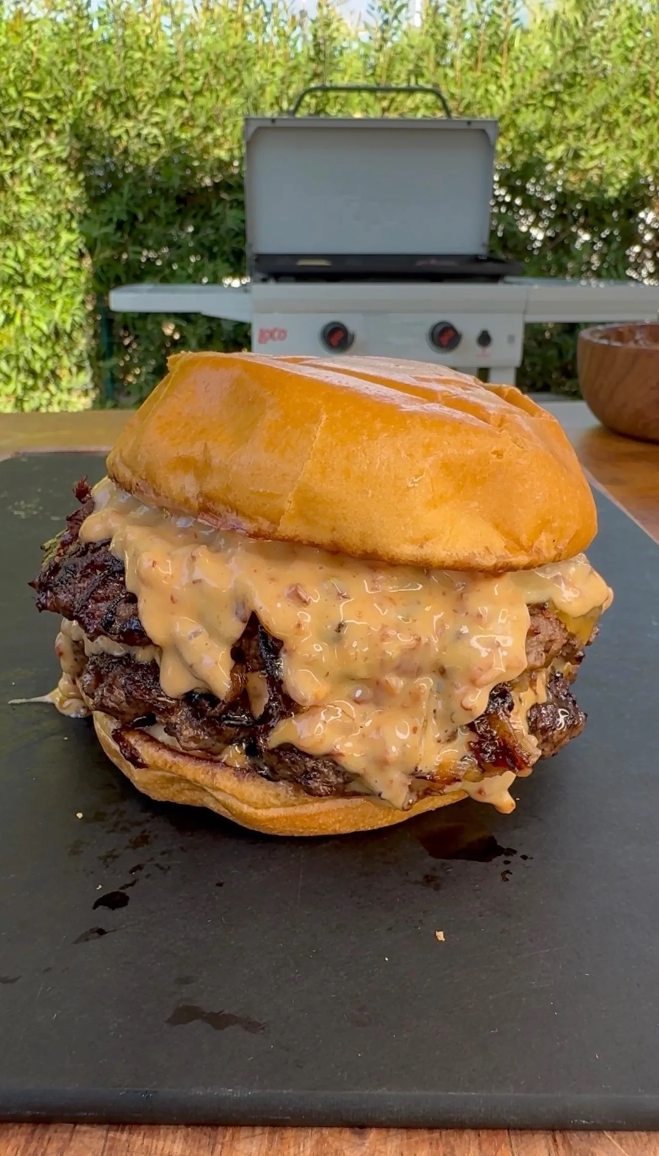 Loaded smash burger with baconnaise sauce on outdoor grill