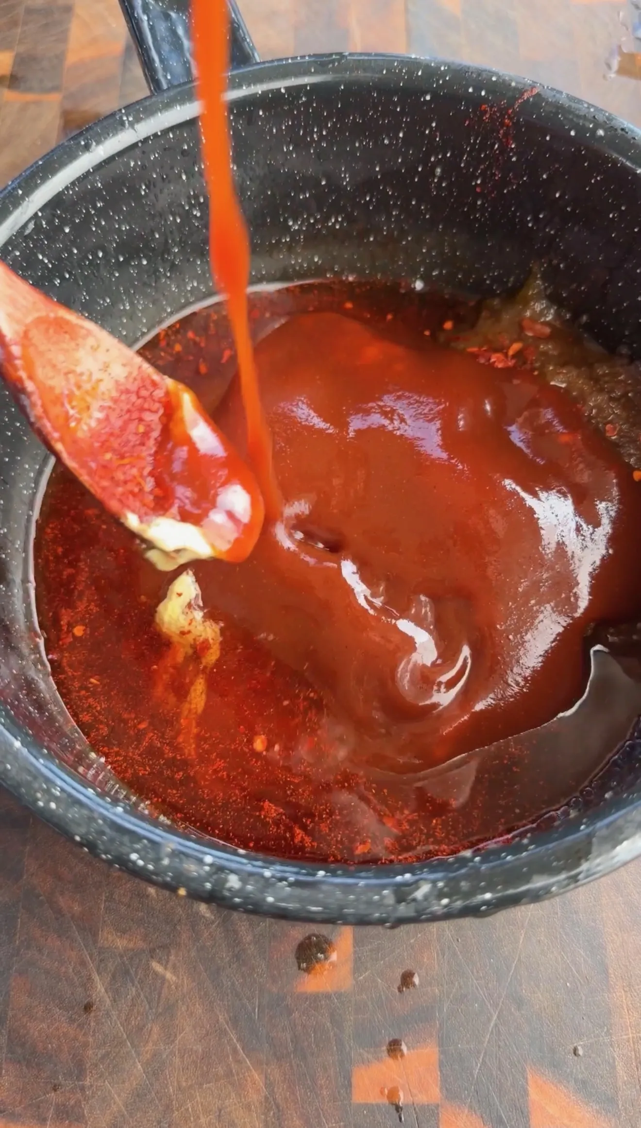 Peach bourbon BBQ glaze cooking in pot