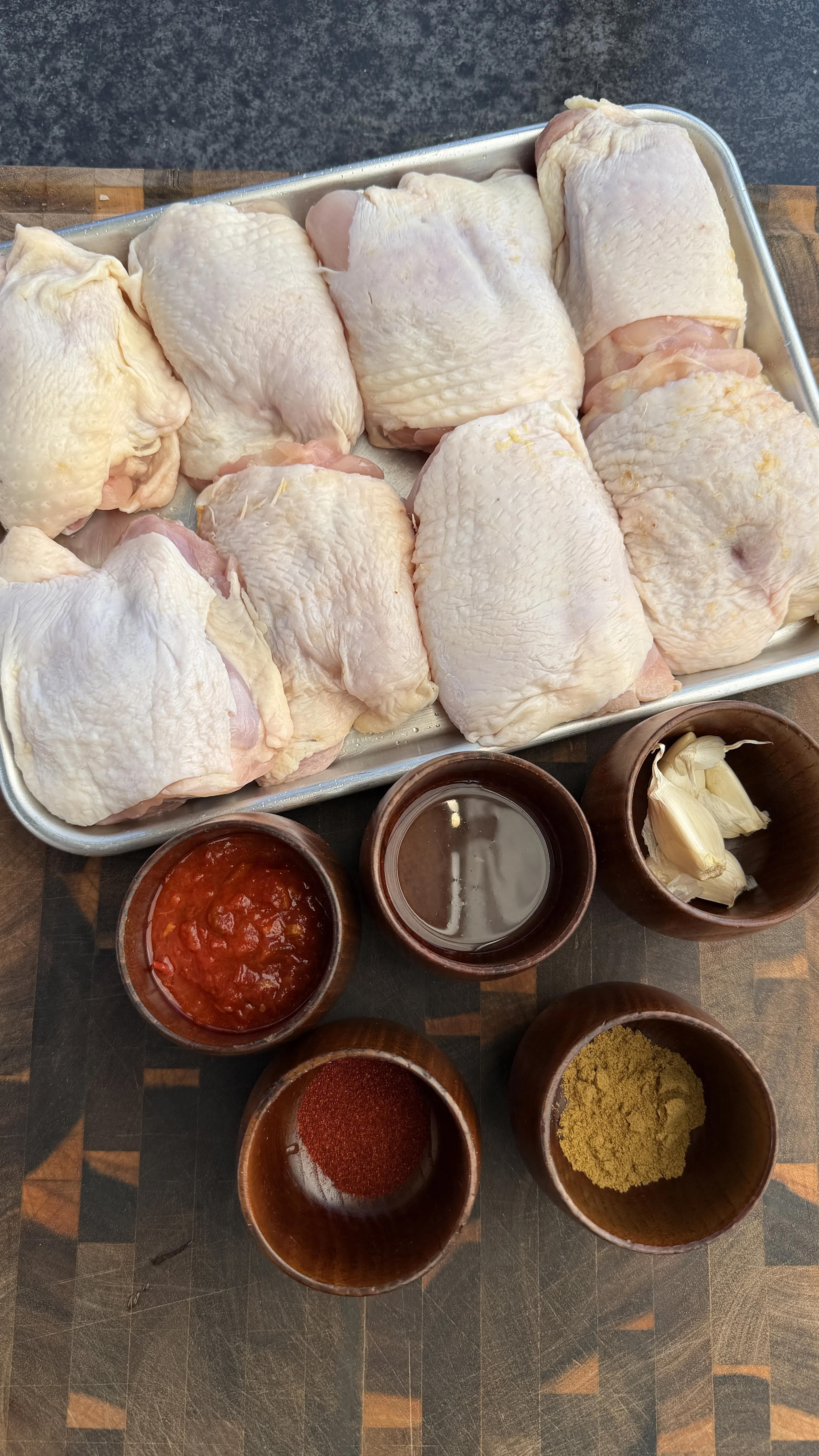 Raw chicken thighs and harissa spices during prep