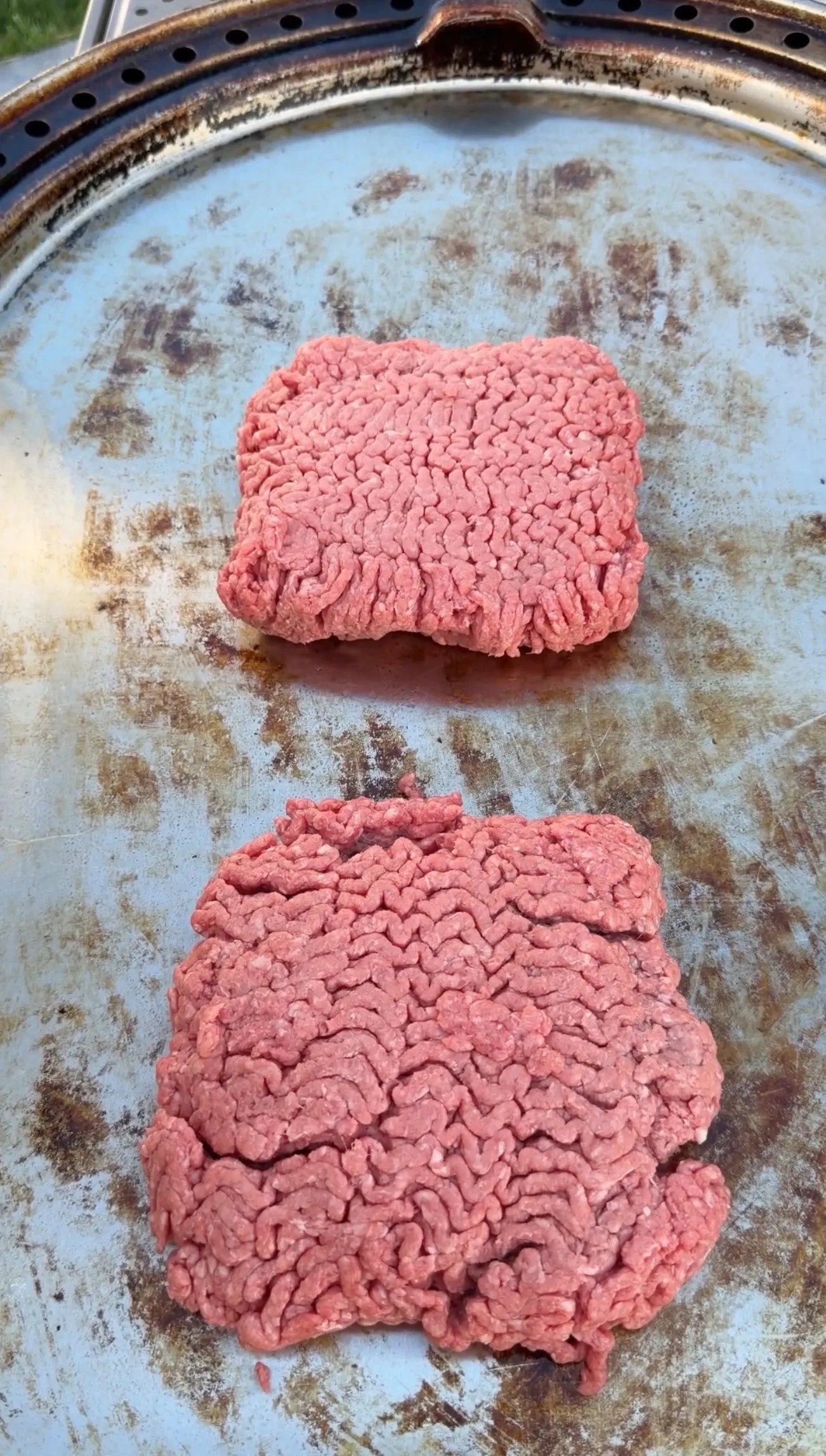 Raw ground beef for crunchwrap filling in a weathered metal pan ready for cooking