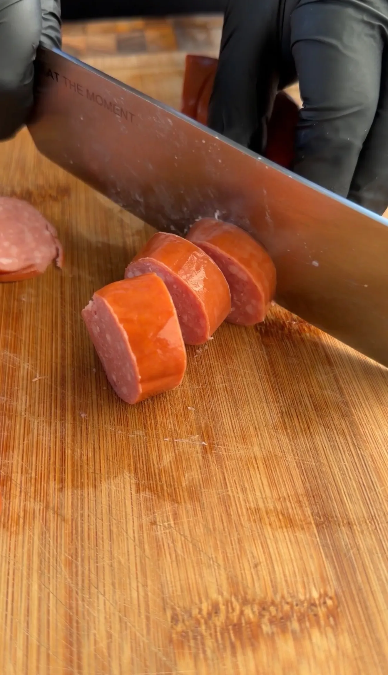 Sliced smoked sausage burnt ends on cutting board