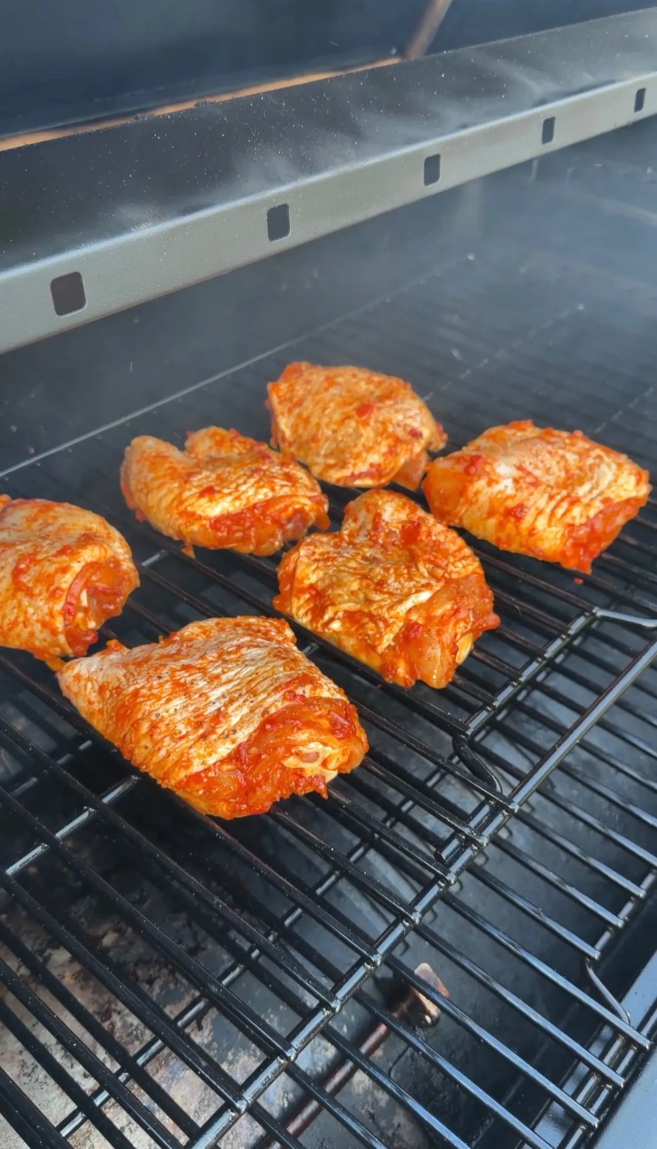 Smoked harissa chicken thighs on grill