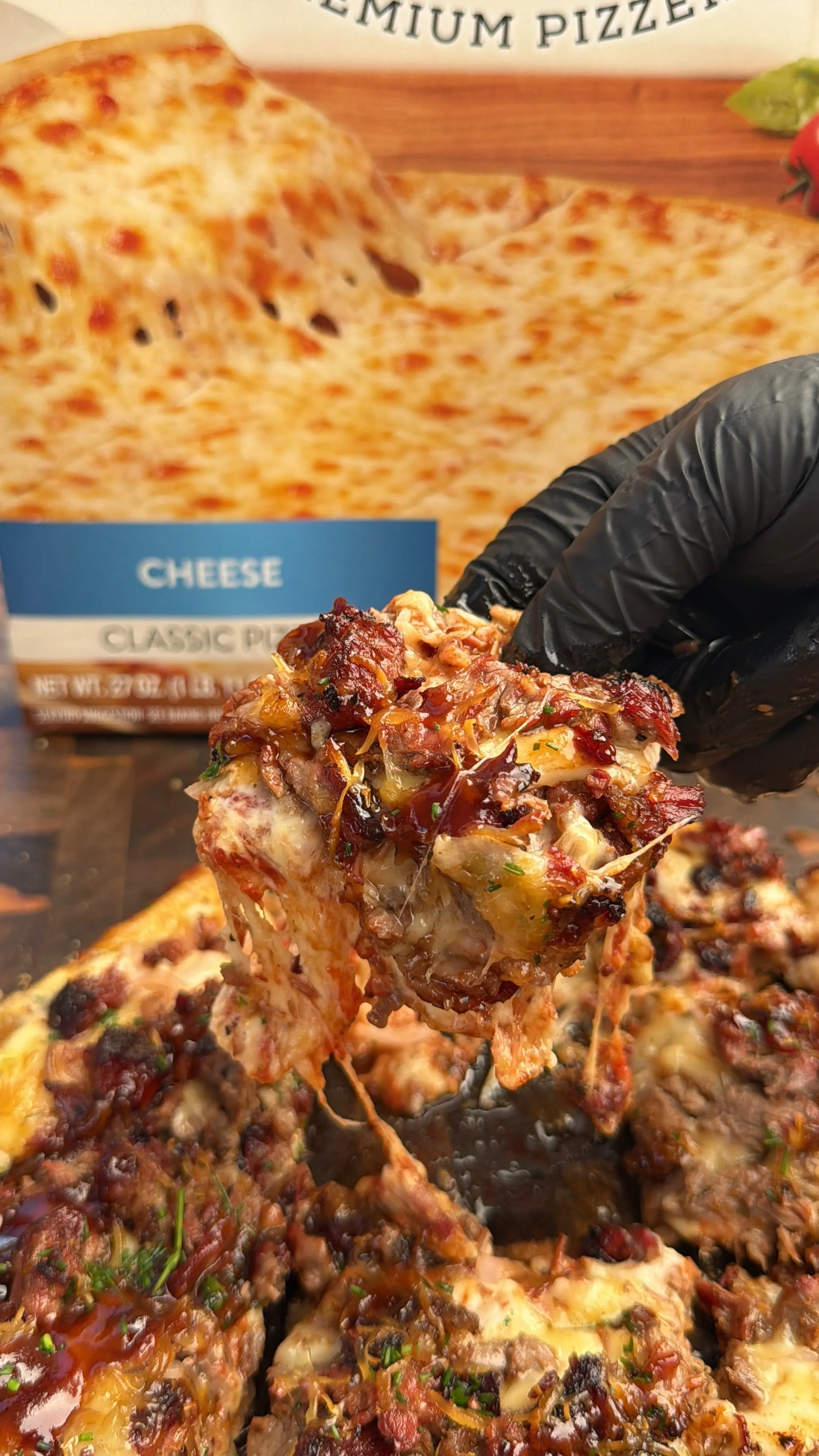 Barbecue brisket pizza slice being lifted with melted cheese stretching from the pan