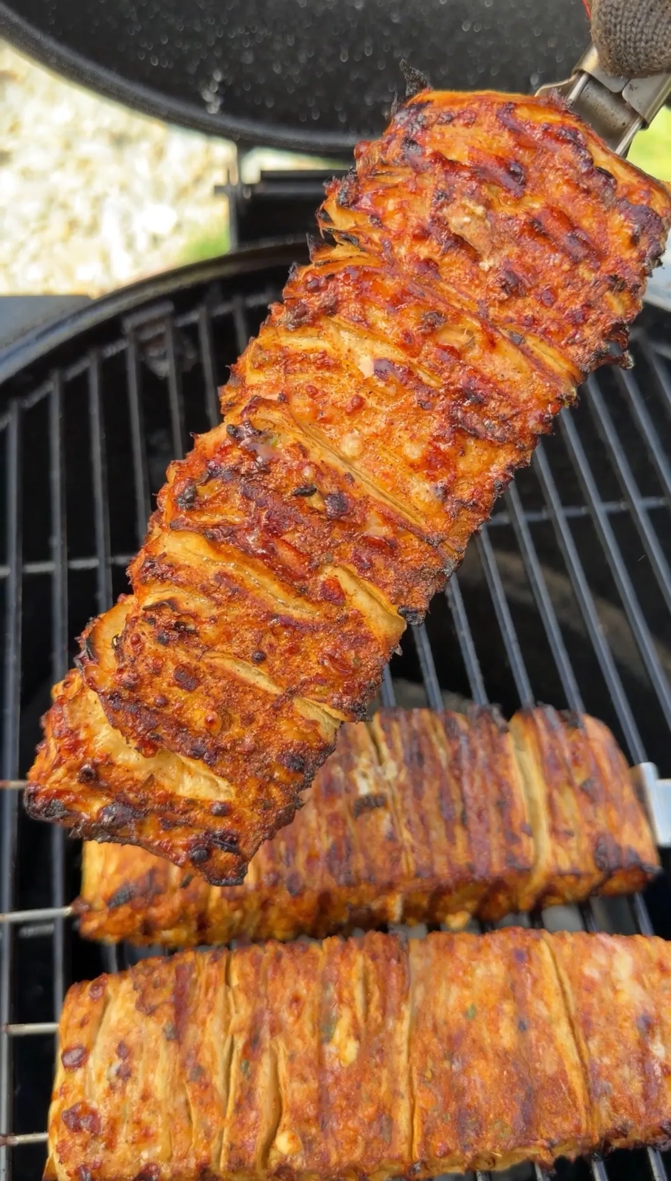 Buffalo chicken tortilla kebabs with golden-brown char marks cooking on grill grates