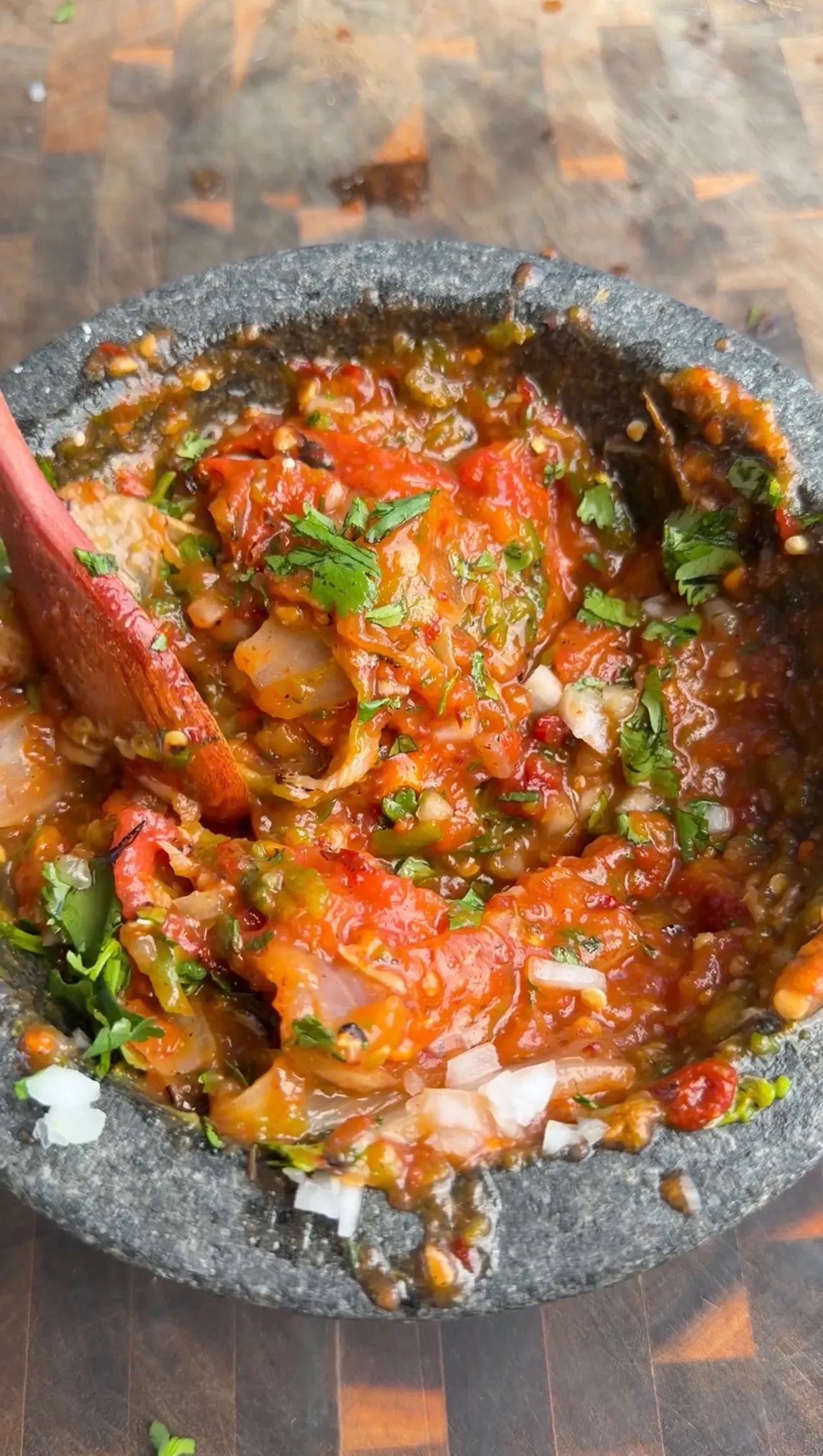 Chipotle salsa with roasted peppers, onions and cilantro in a traditional stone molcajete bowl