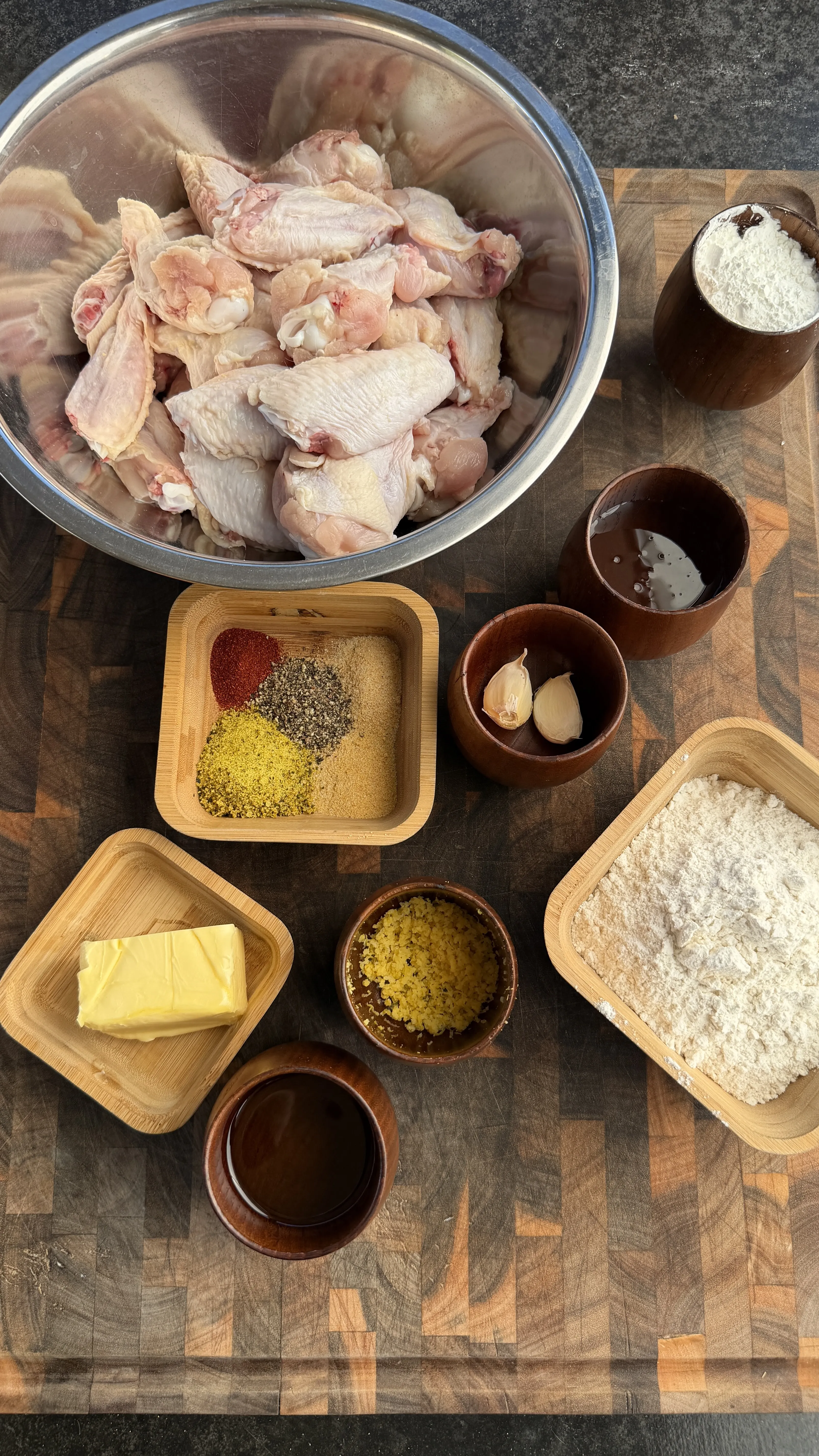 Raw chicken wings with flour, butter, spices, garlic, and sauces for crispy fried honey lemon pepper wings