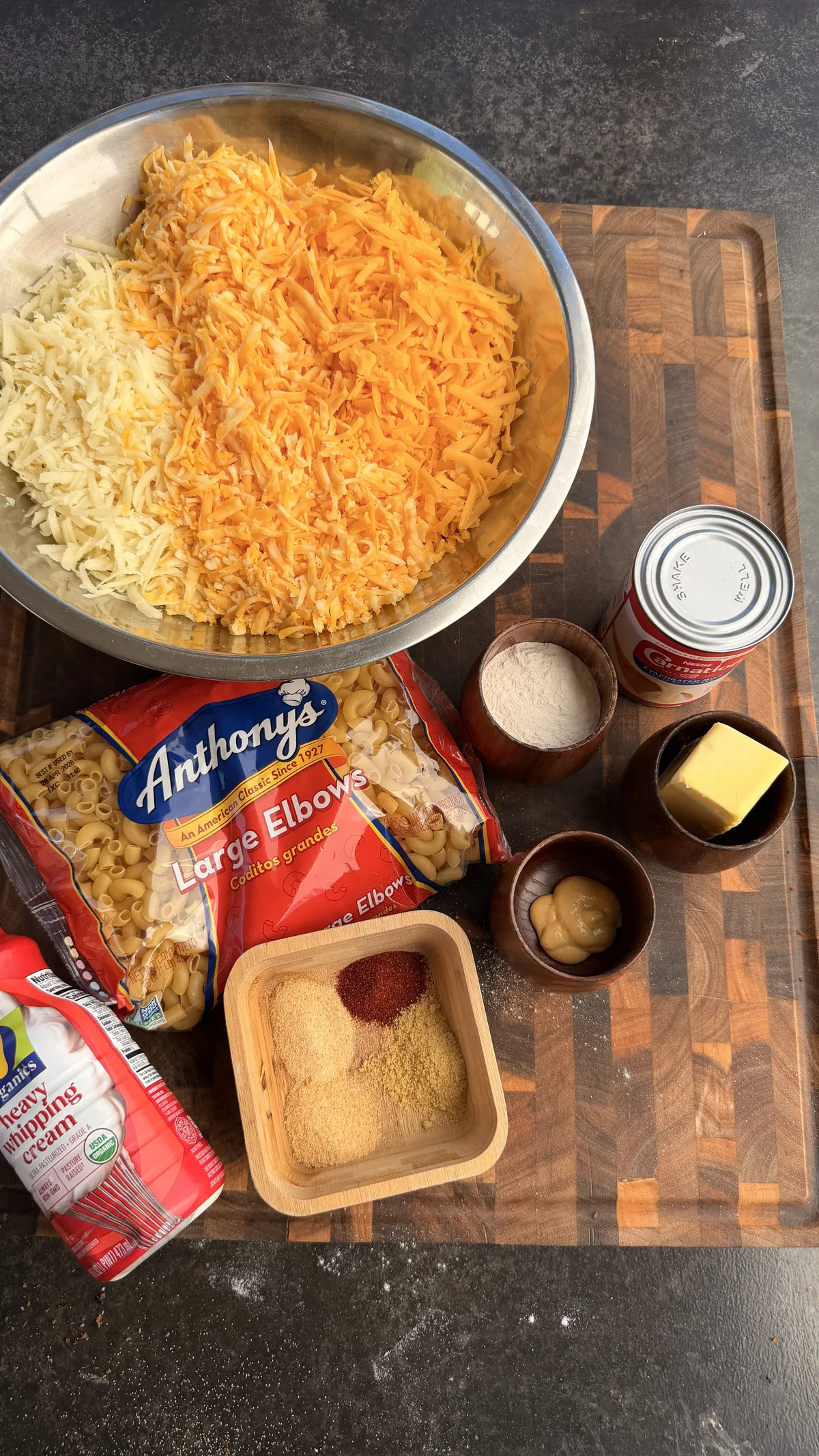 Ingredients for creamy baked mac and cheese: shredded mozzarella and Colby Jack, elbow macaroni, evaporated milk, butter, flour, Dijon mustard, and spices