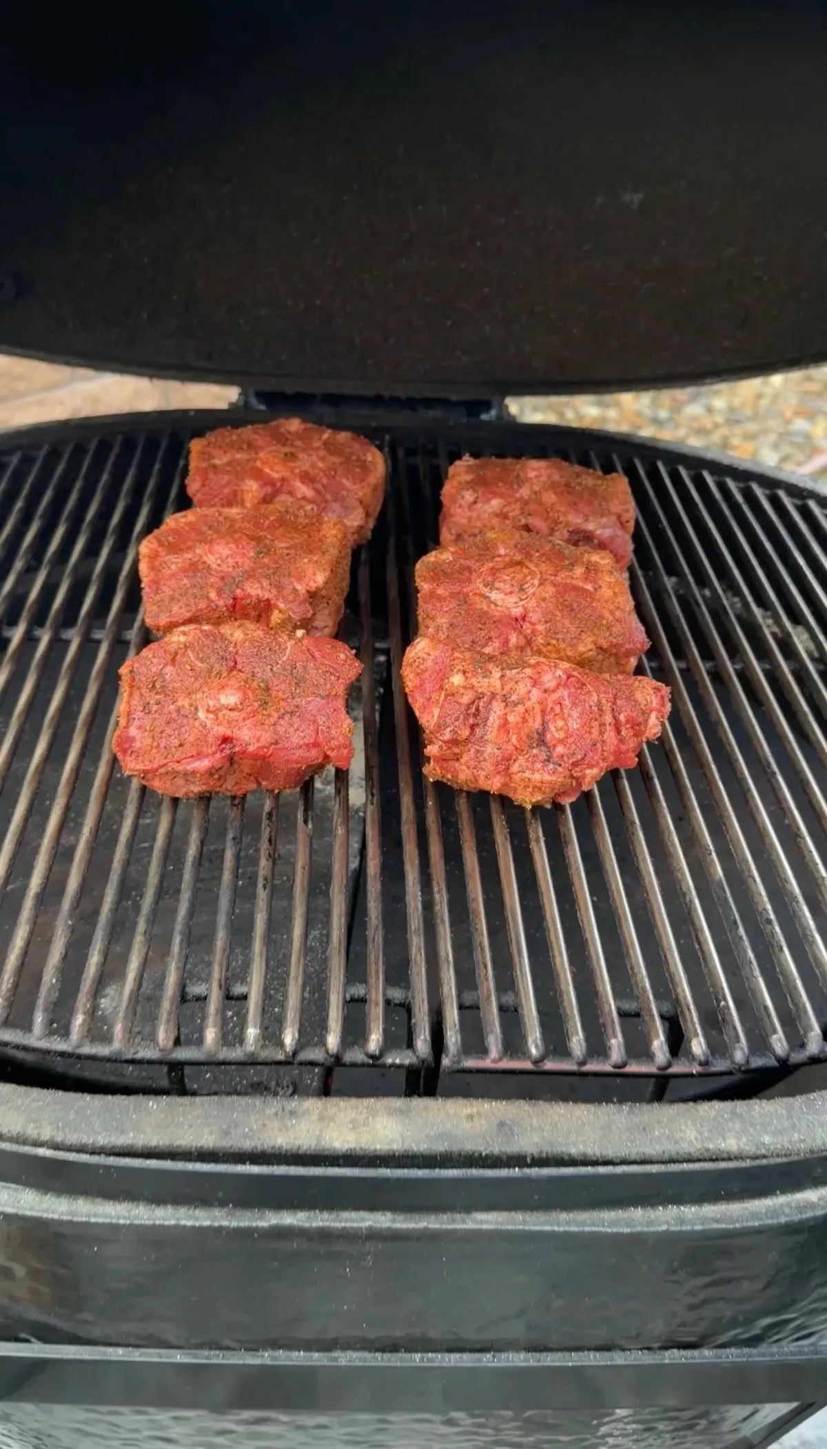 Six pounds of BBQ-seasoned beef oxtails placed directly on smoker grill grates at 250°F