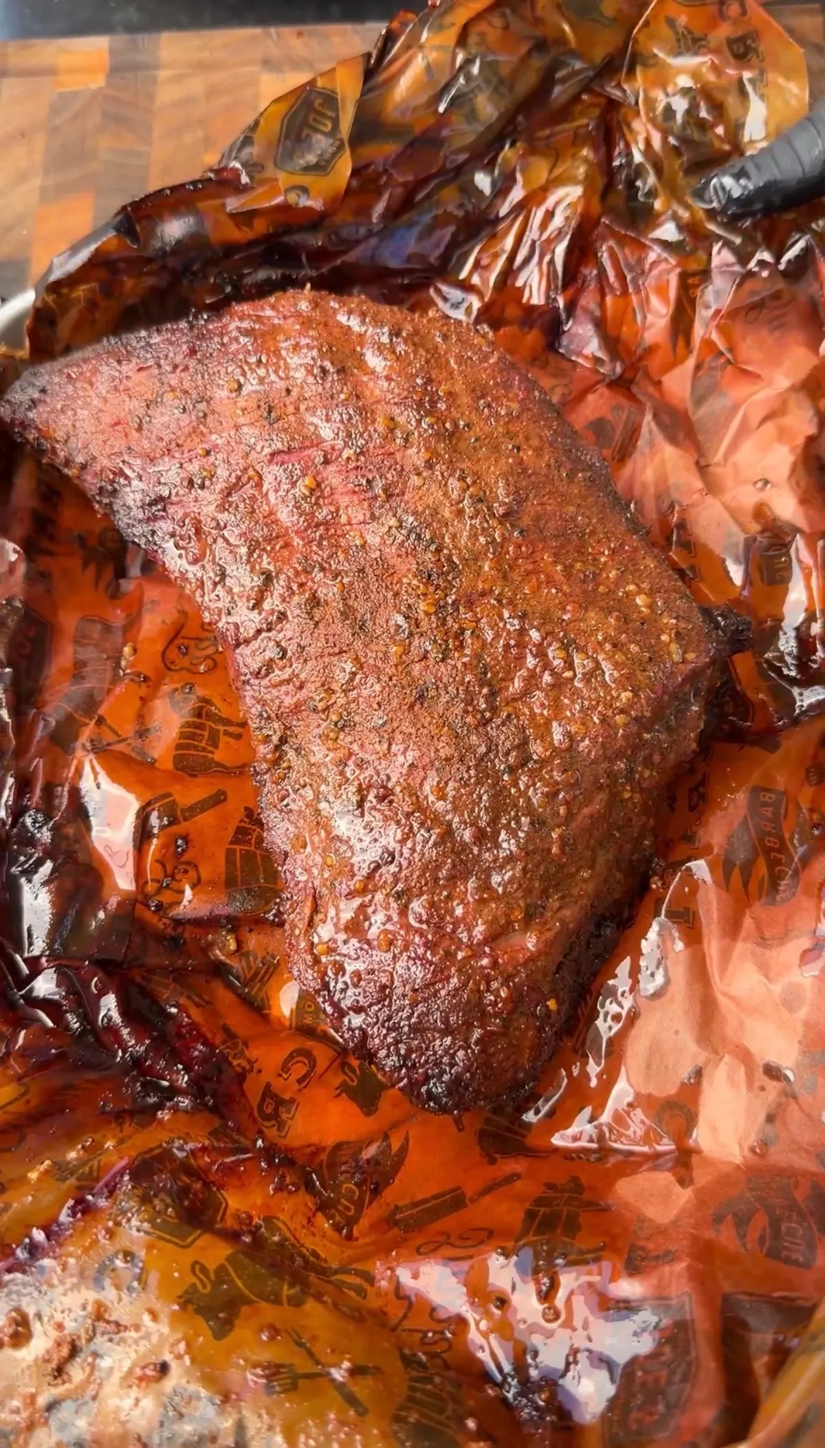 Juicy smoked trisket (tri-tip cooked like brisket) with dark bark crust unwrapped in butcher paper