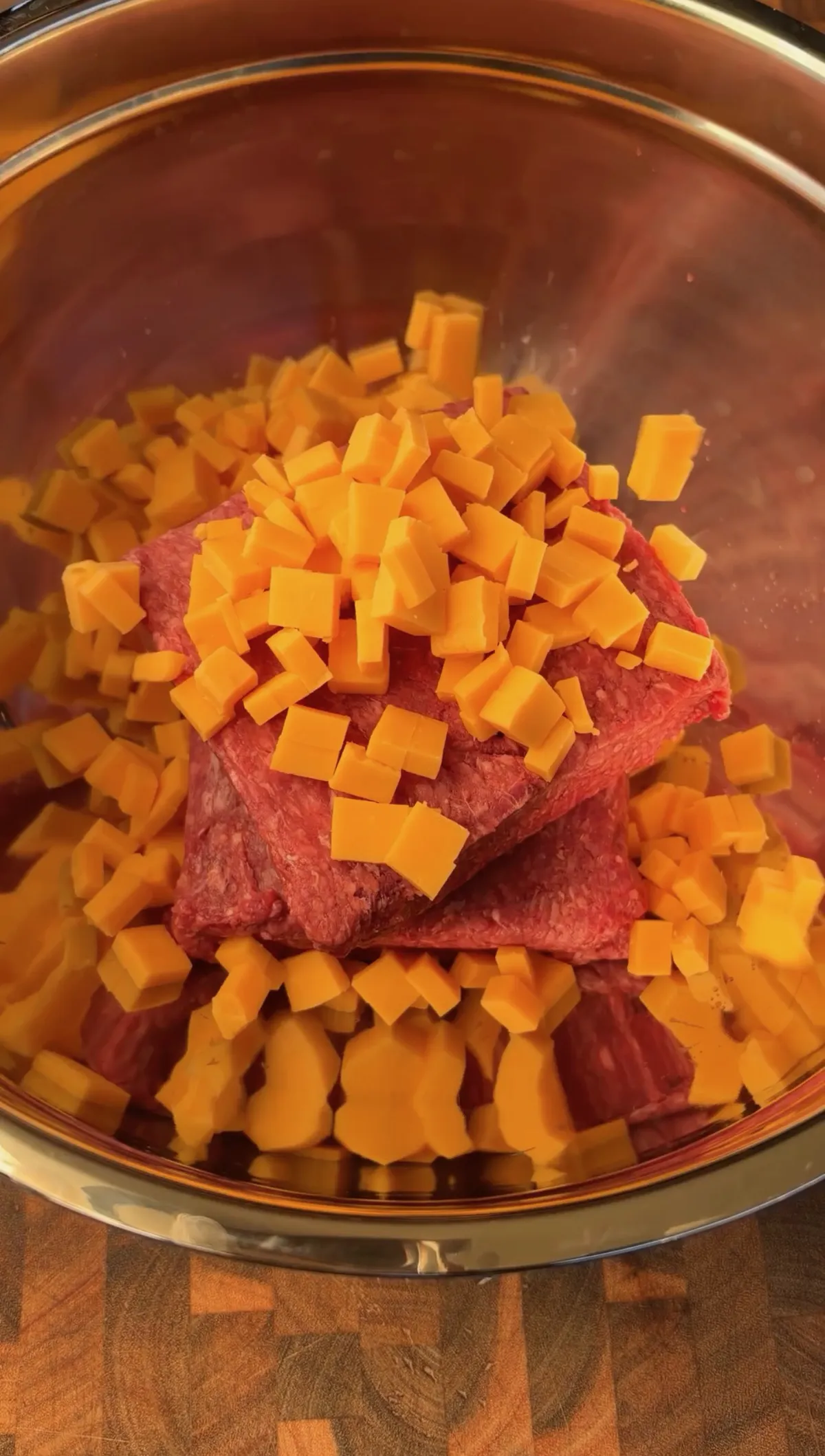 85/15 ground beef and cubed cheddar cheese combined in a large mixing bowl for smoked stuffed burgers