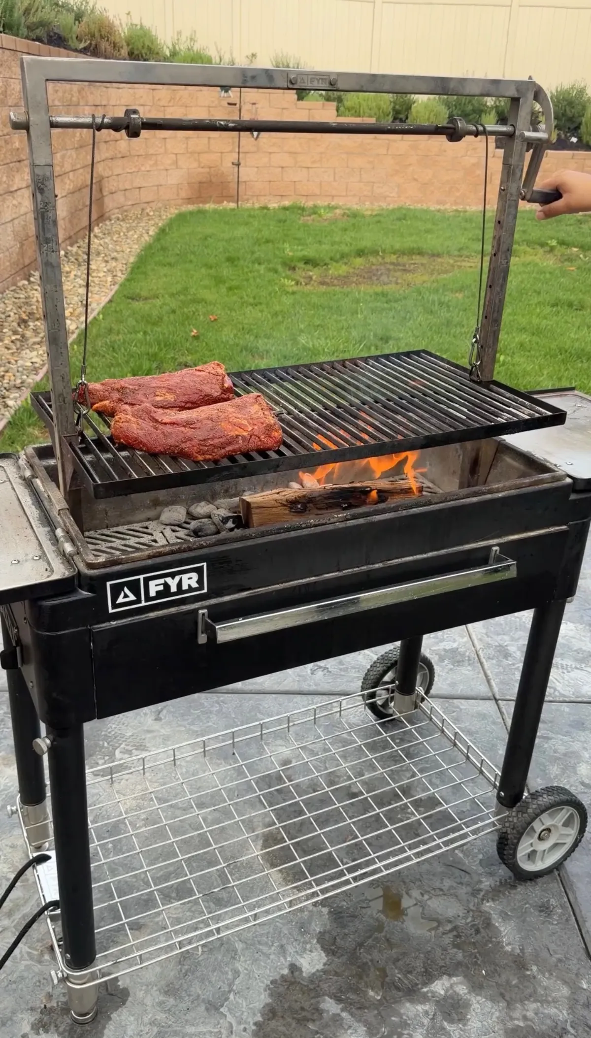 Tri-tip with mud rub cooking fat cap down on a Santa Maria grill over charcoal and hickory wood fire