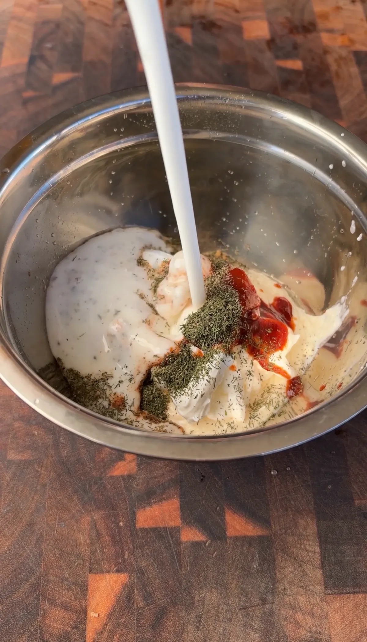 Mayonnaise, sour cream, chipotle peppers, adobo sauce, and dried dill combined in a stainless steel mixing bowl