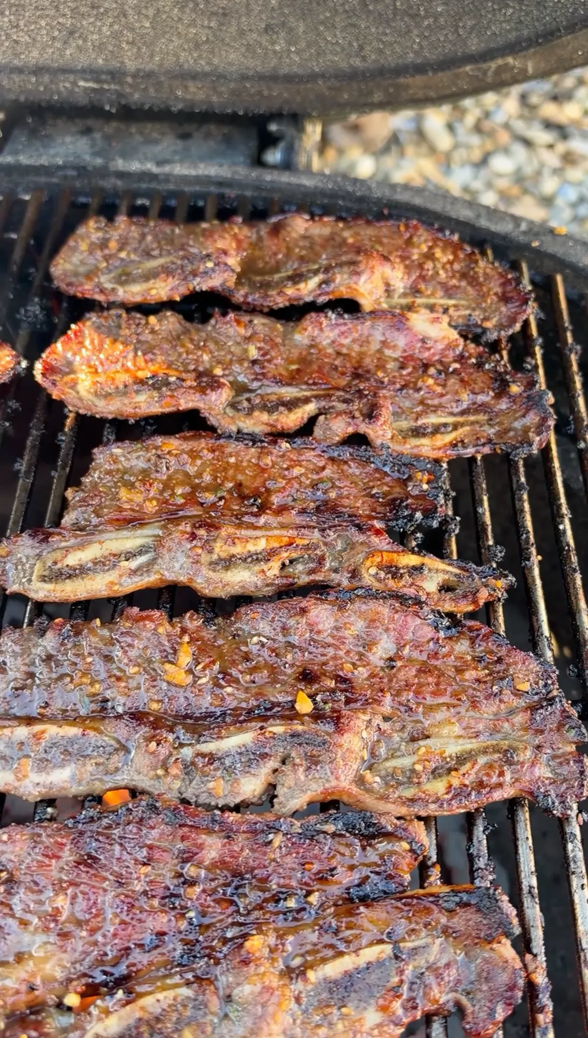 Korean kalbi flanken-cut beef short ribs with sticky caramelized soy marinade grilling over direct high heat