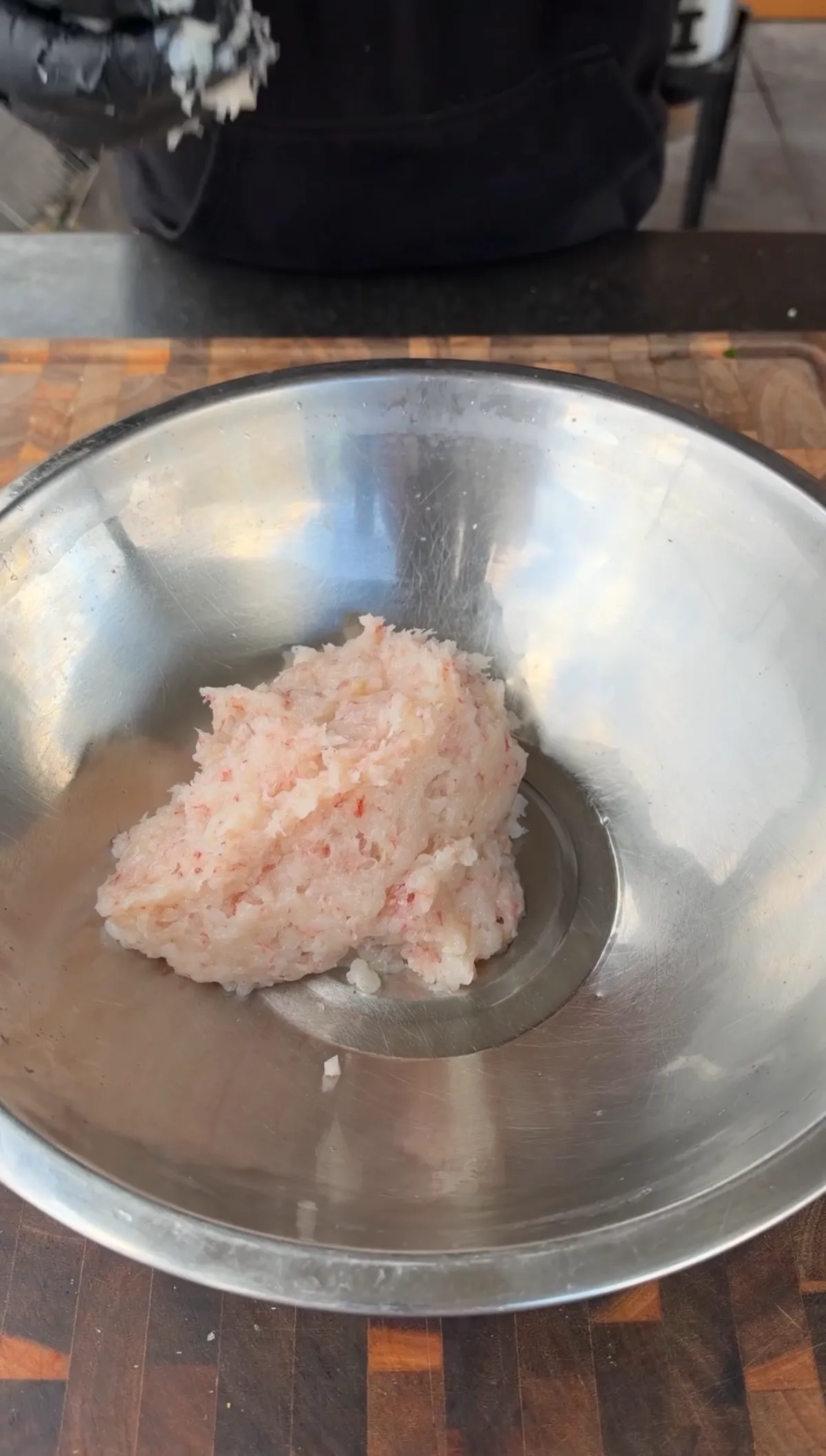 Roughly chopped raw Argentine shrimp mixture in a stainless steel mixing bowl ready for seasoning