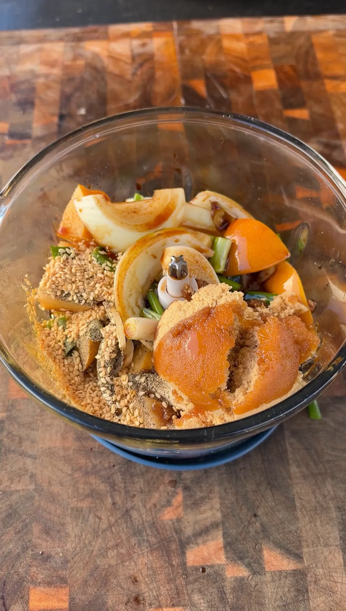 Asian pears, yellow onion, green onions, sesame seeds, and brown sugar in a food processor bowl for Korean Kalbi marinade